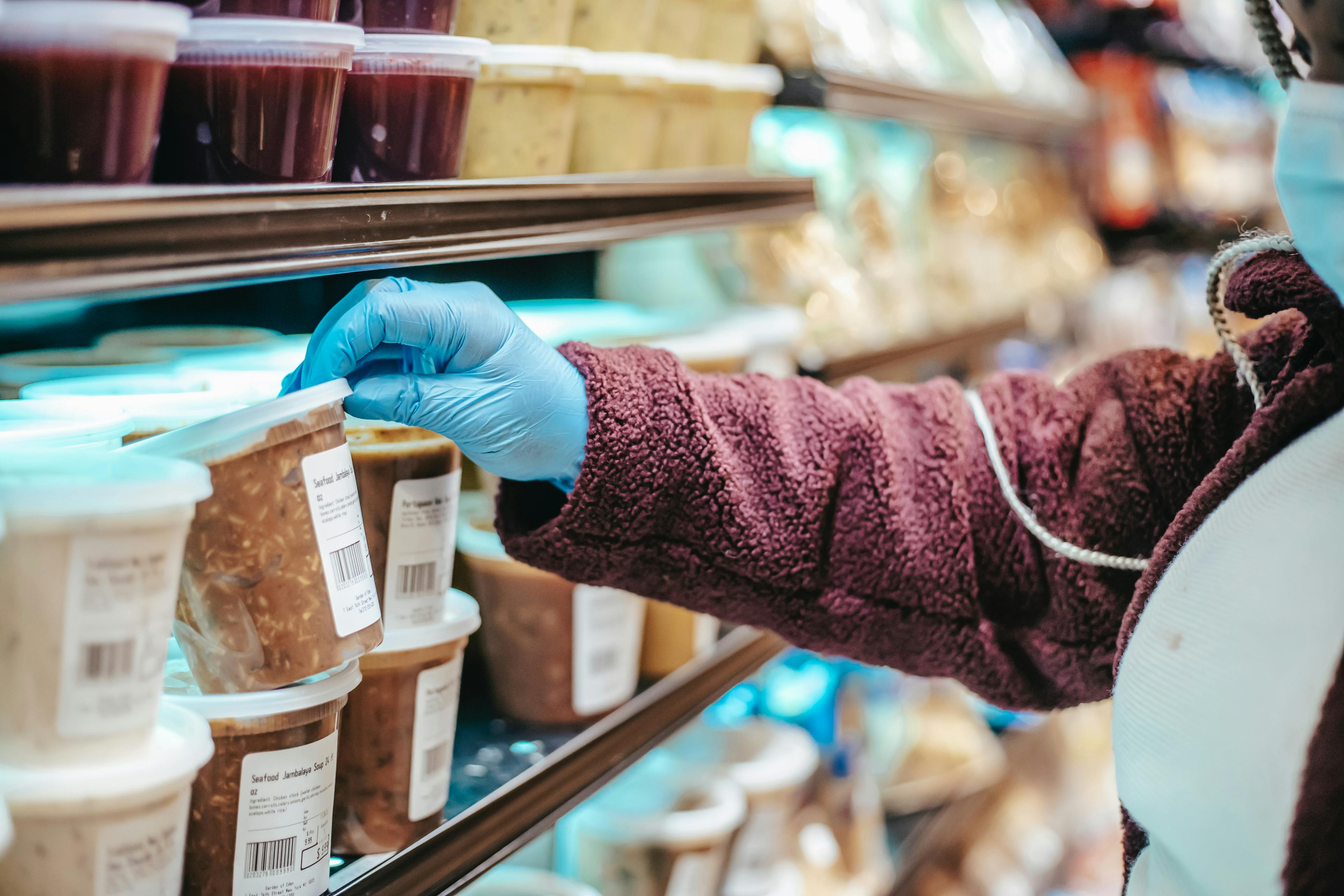 Delivery courier picking up soup at grocery store. 