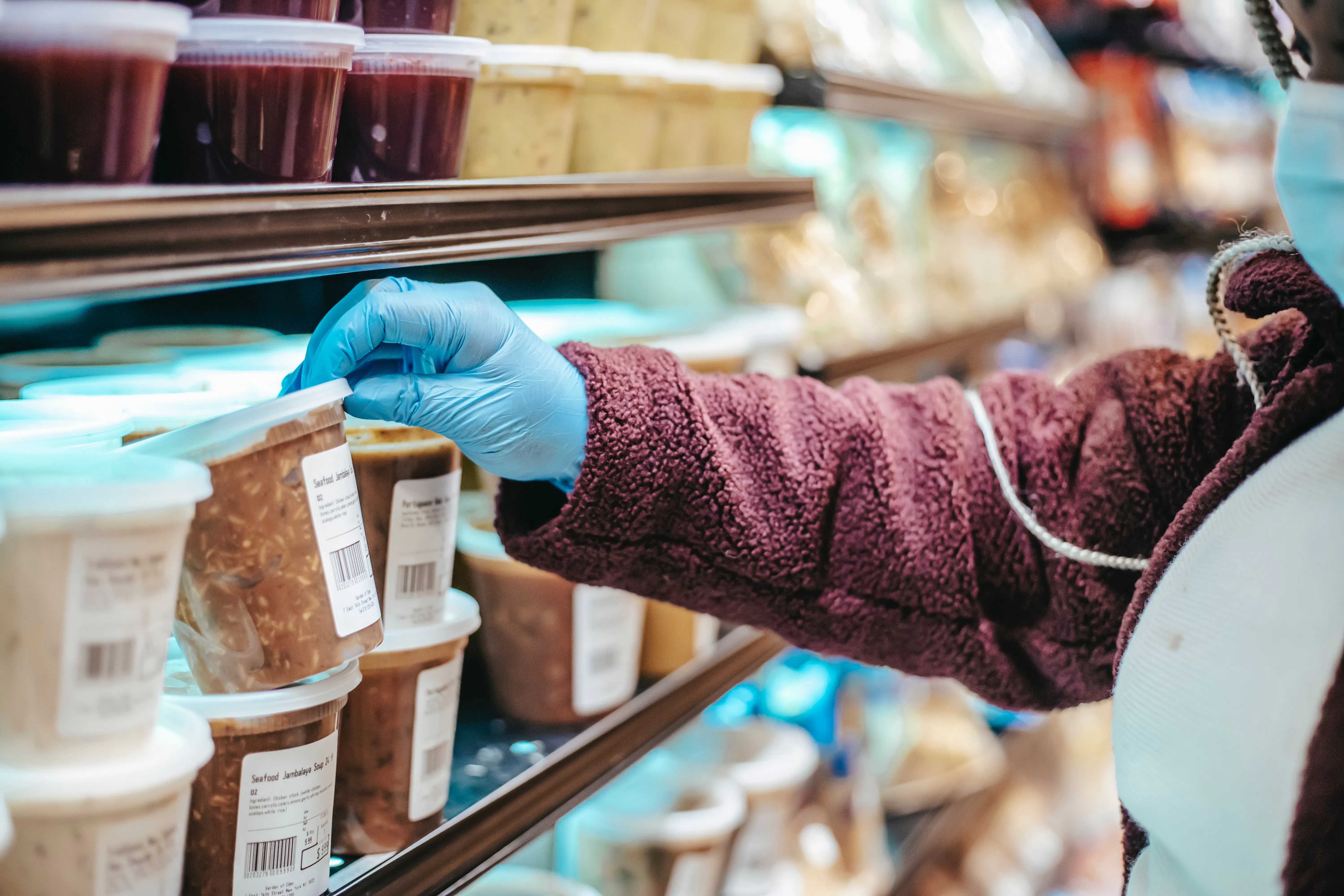 Delivery courier picking up soup at grocery store.