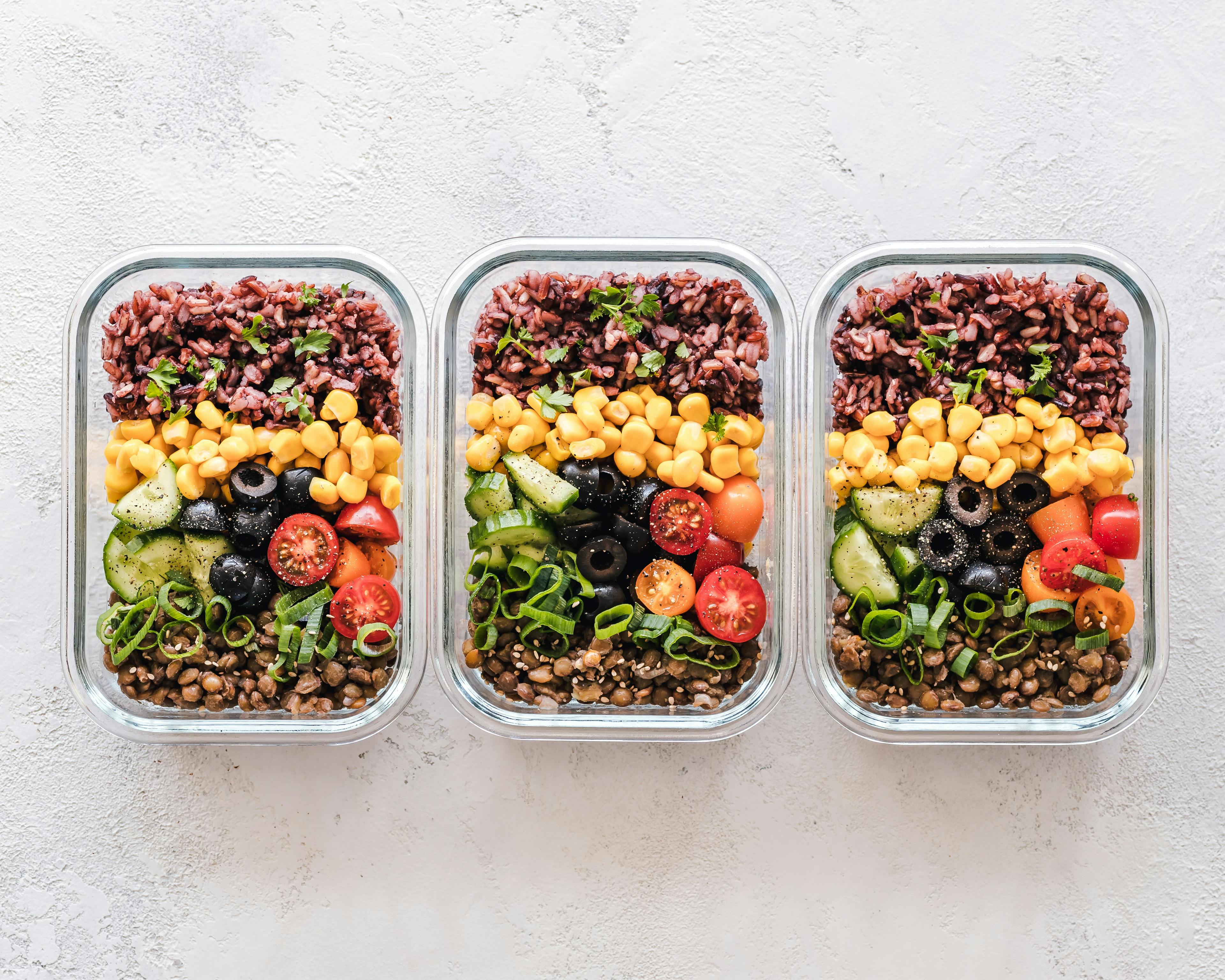 Tupperware of three meal-prep meals.