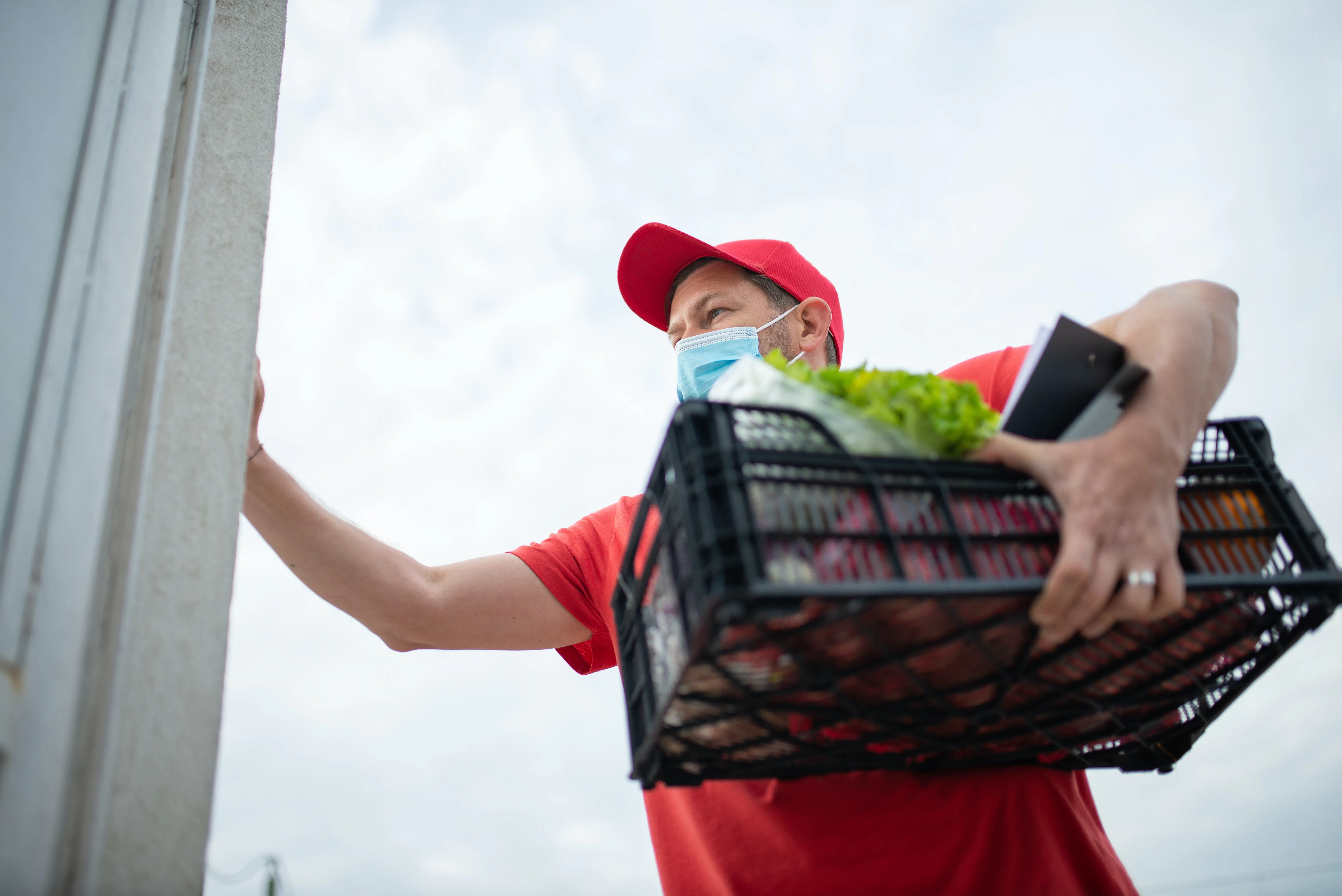 Grocery delivery courier loading truck.