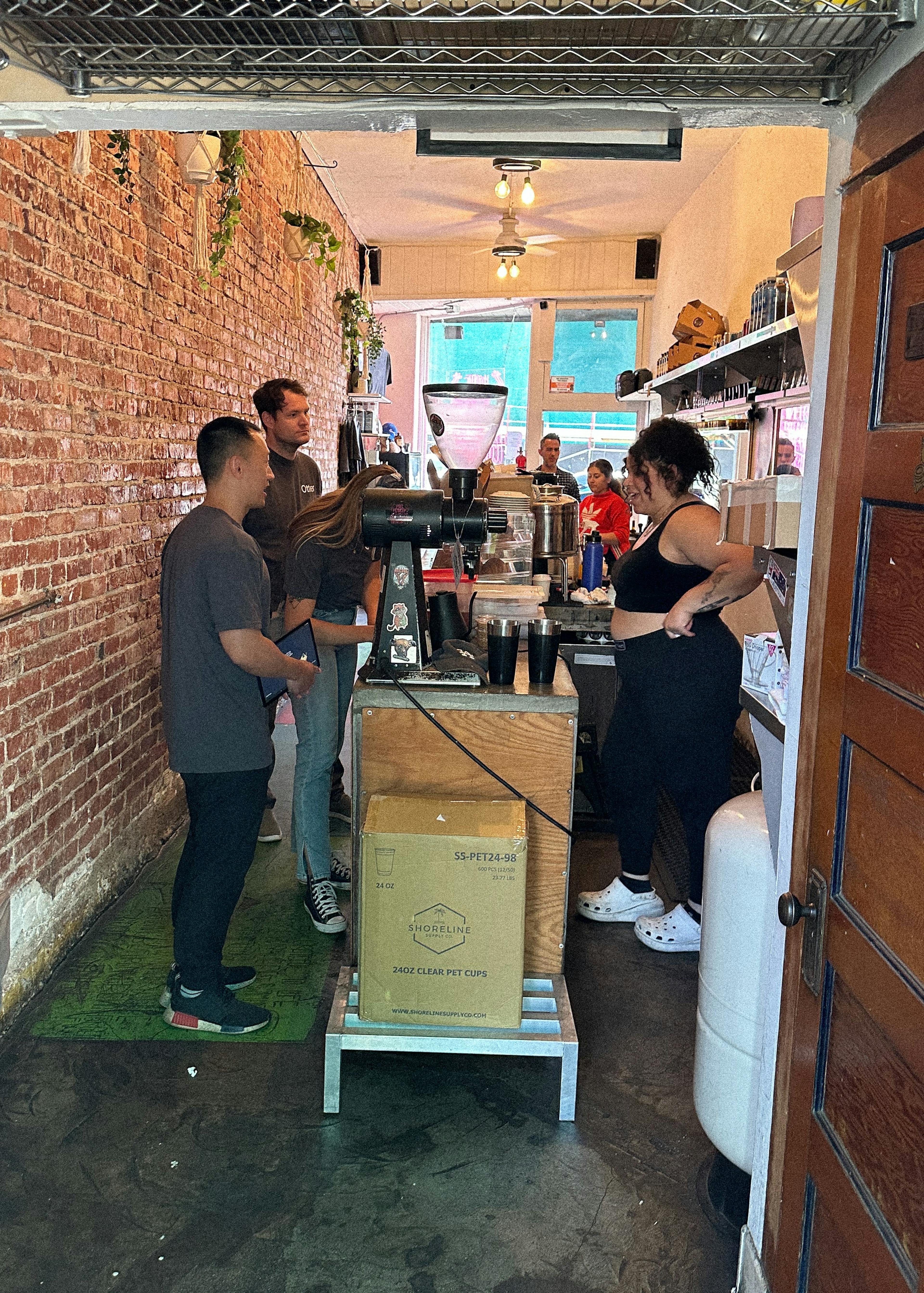 Otter team visiting restaurant with brick wall. 