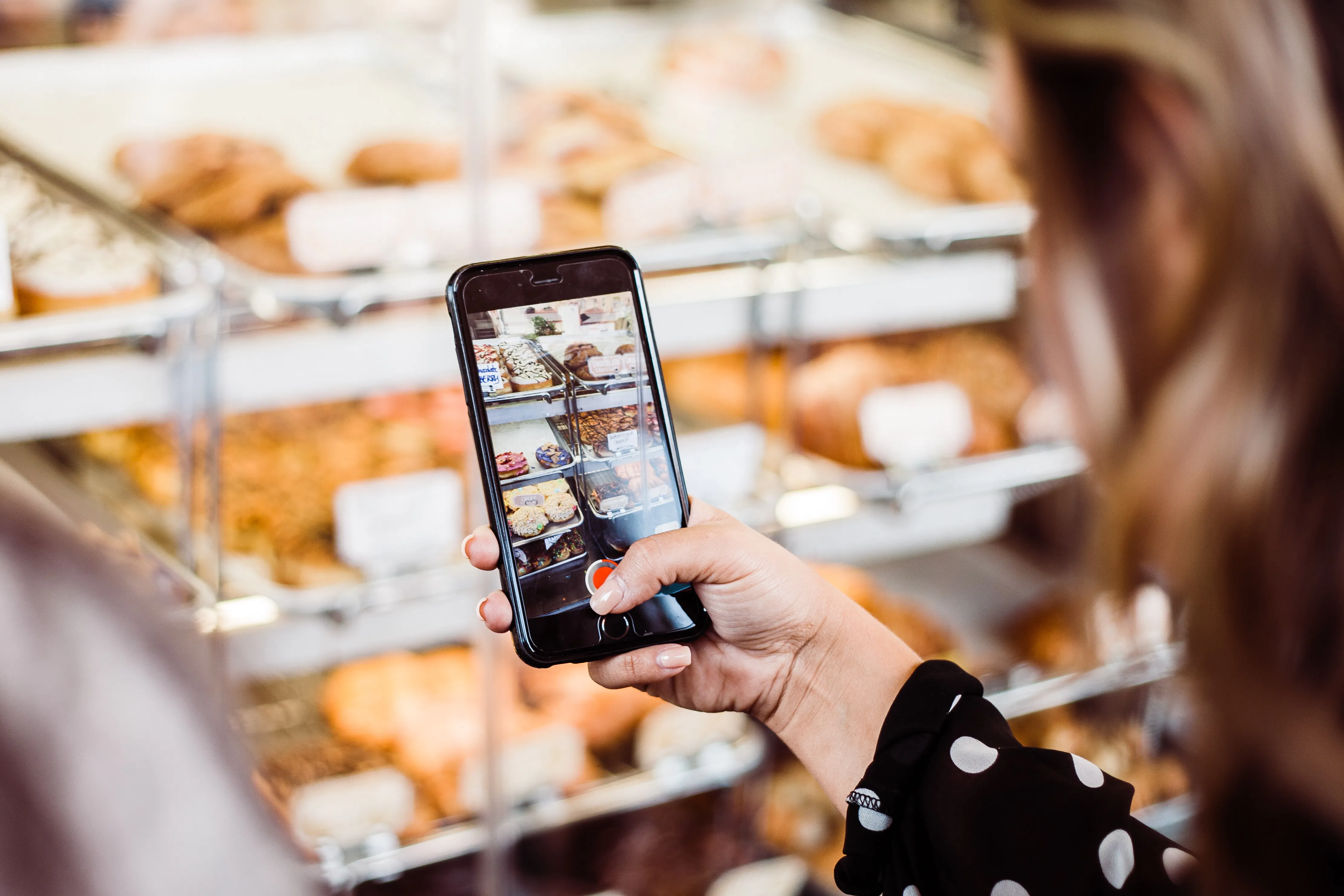 Woman taking an instagram picture of food. 