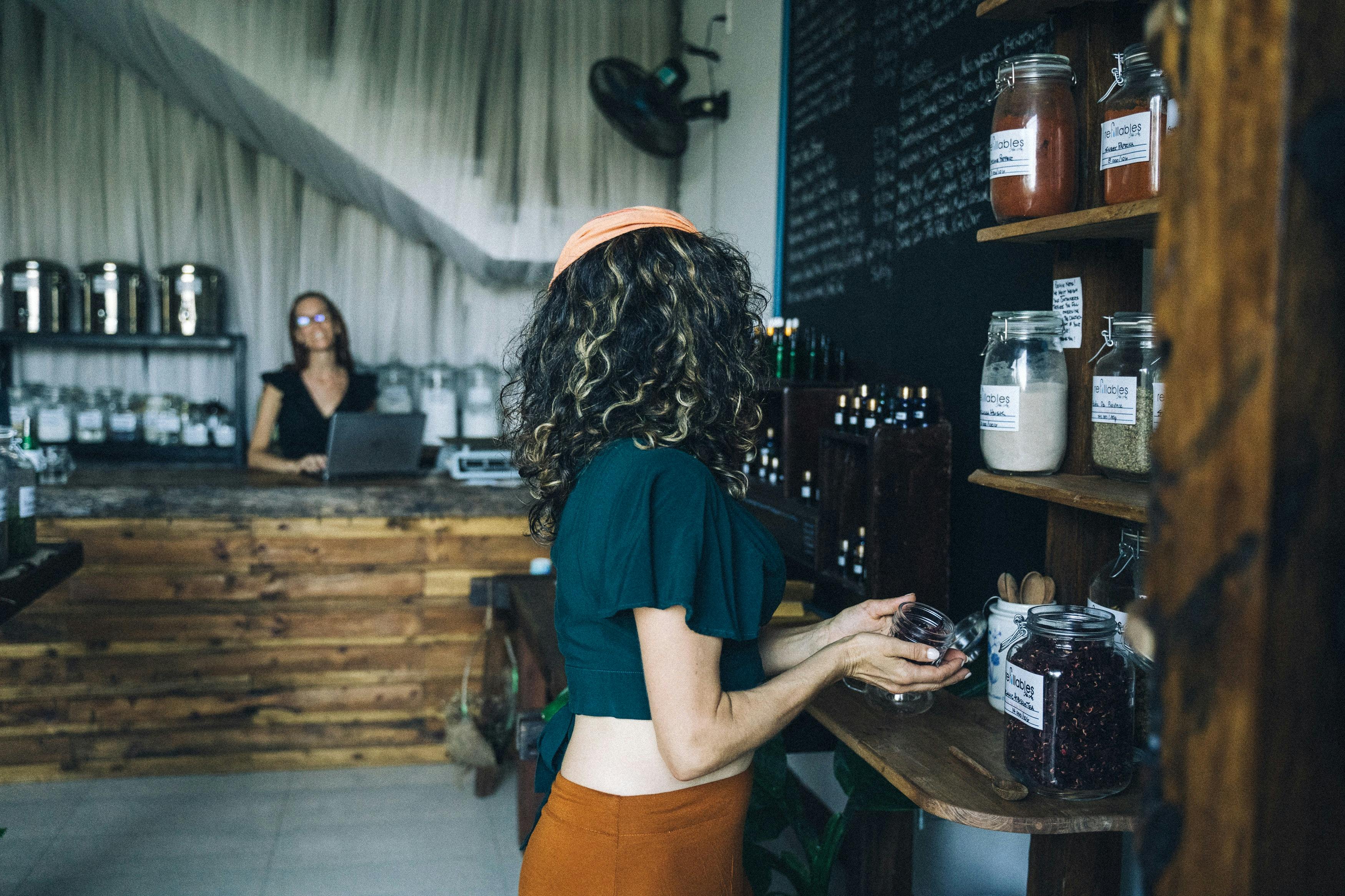 Image of a customer looking at items in a restaurant with natural, sustainable decor