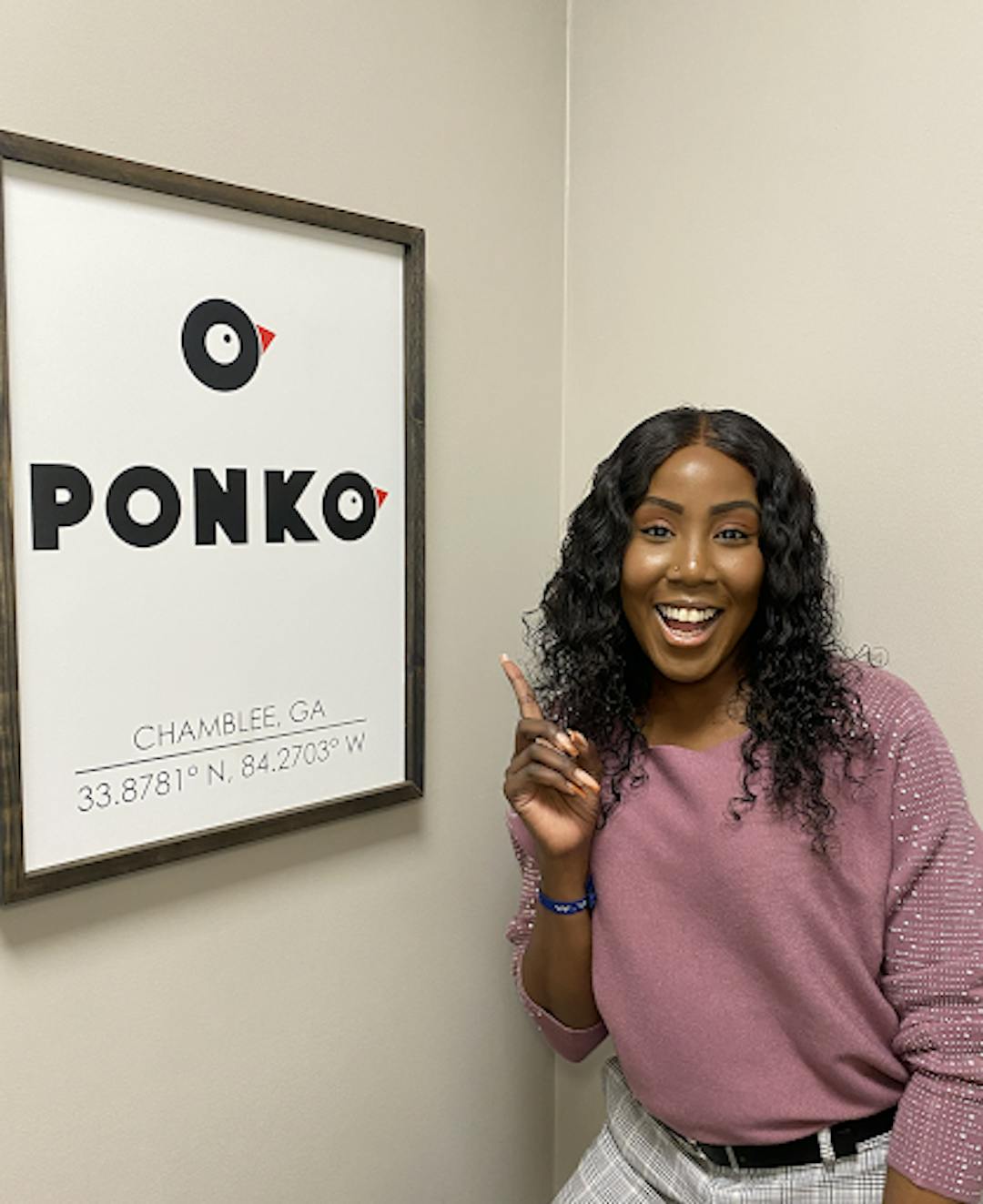 PONKO Chicken's Restaurant Marketing Manager, Precious O'Brien next to the PONKO logo.