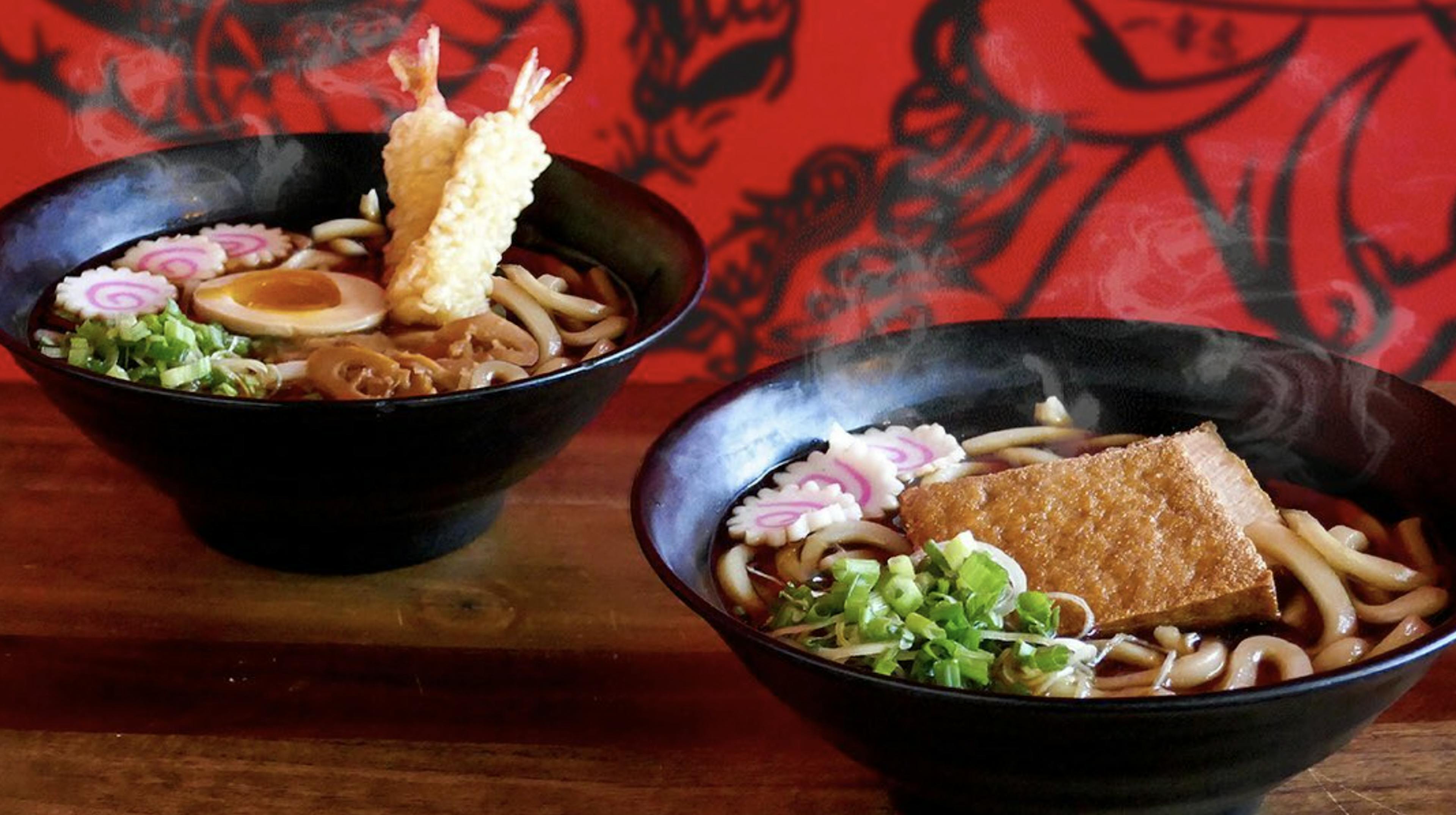 Image of two bowls of ramen on a table, one with shrimp, one with tofu