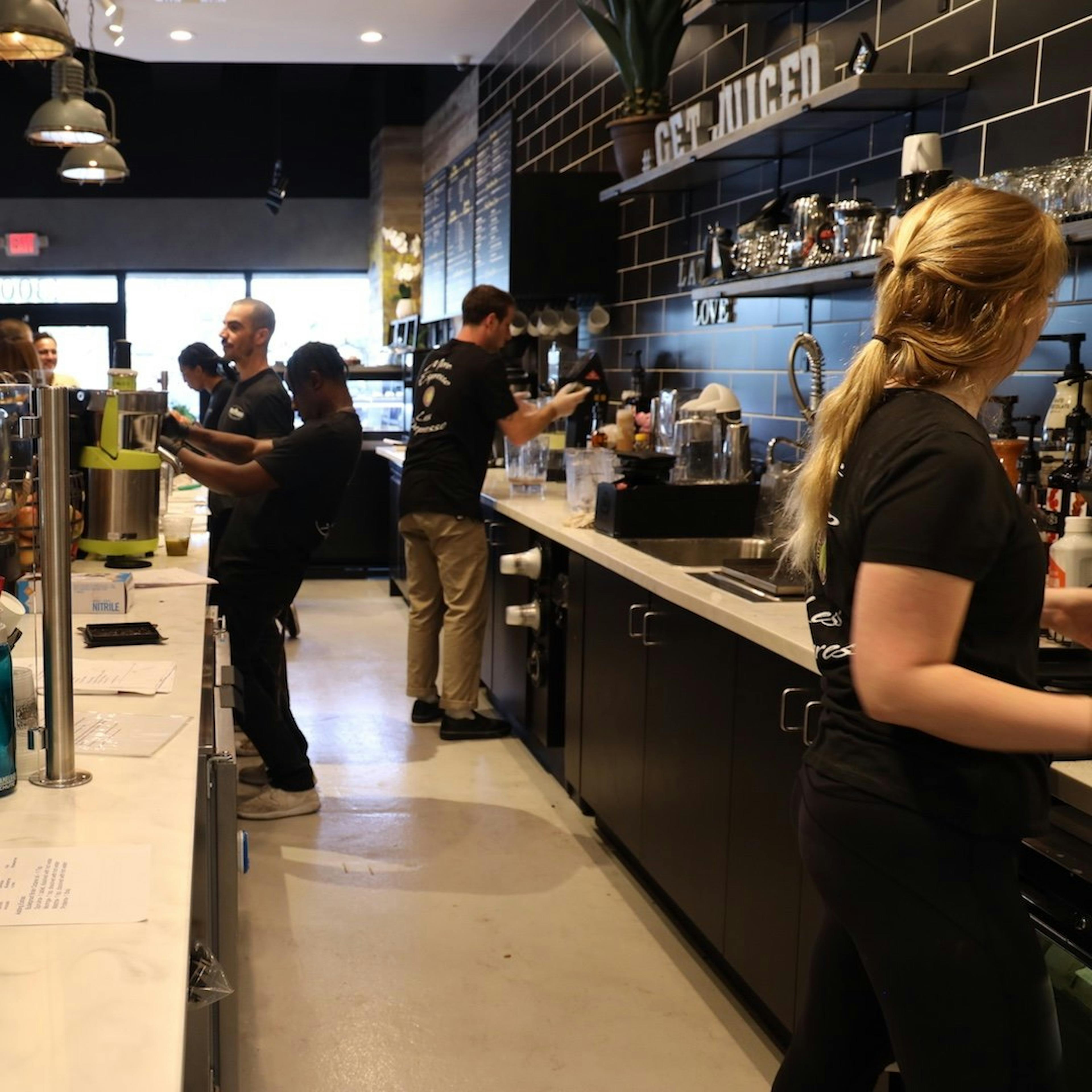 Image of the Press & Grind Cafe staff preparing smoothies and coffee