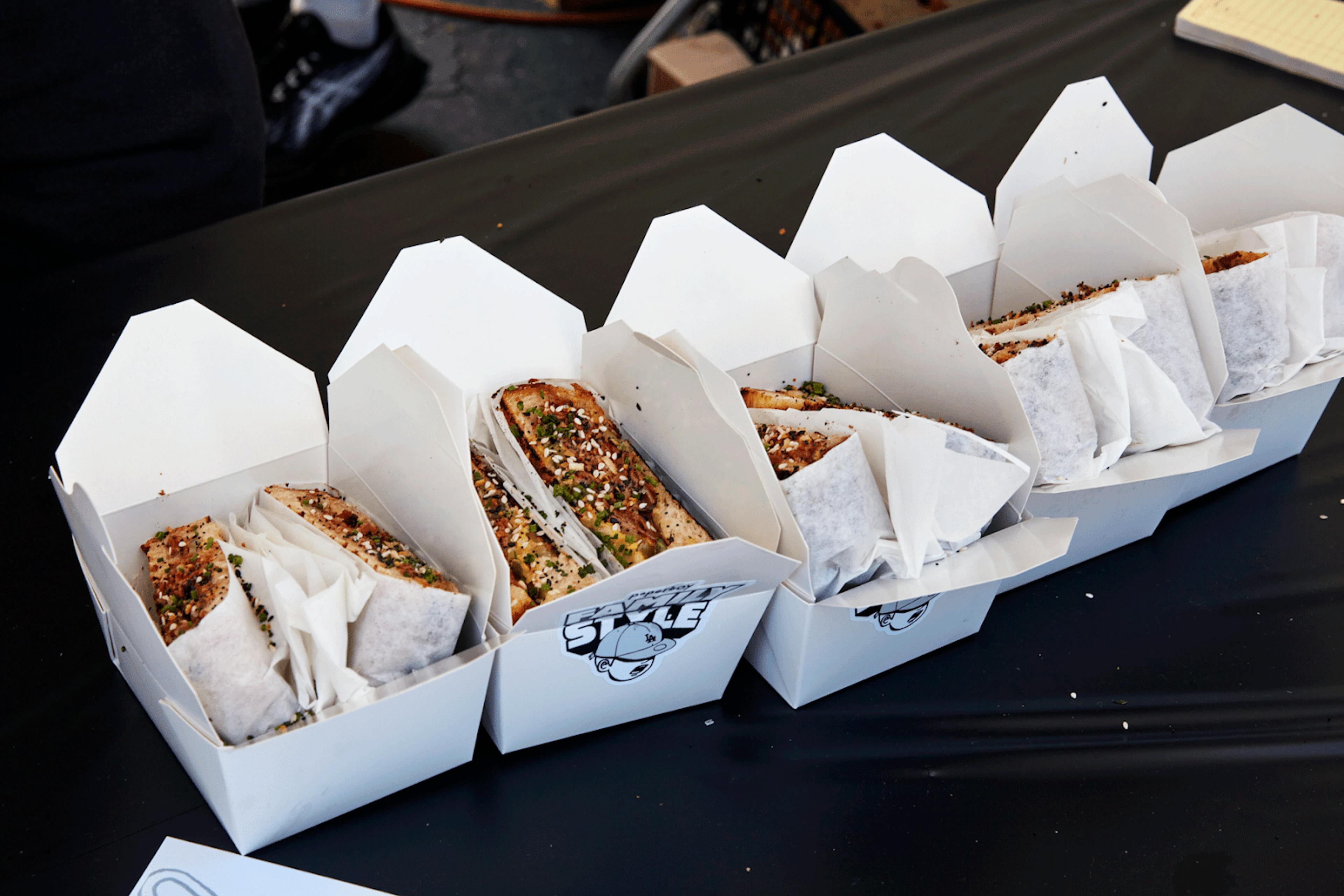 Image of food packed in to-go delivery containers