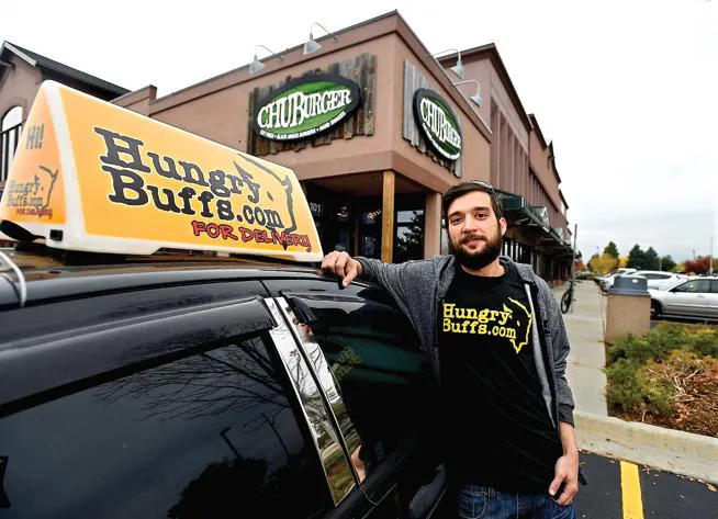 Image of LoDel founder with his arm on top of a delivery courier's vehicle