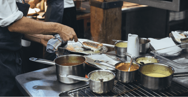 Image of a restaurant employee preparing food in the kitchen