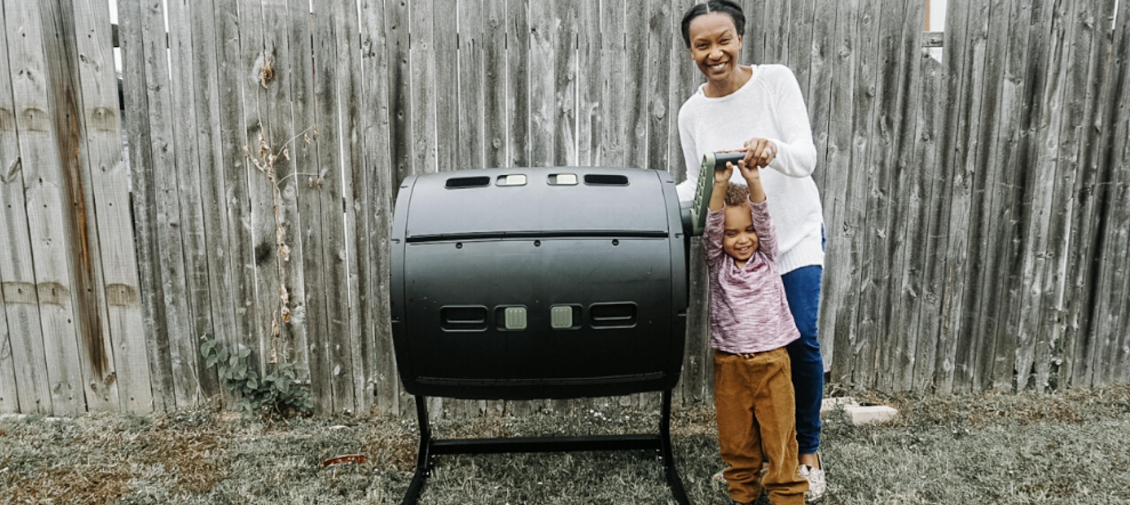 Image of Addie Fischer, sustainable living influencer, and her son in front of their composting container