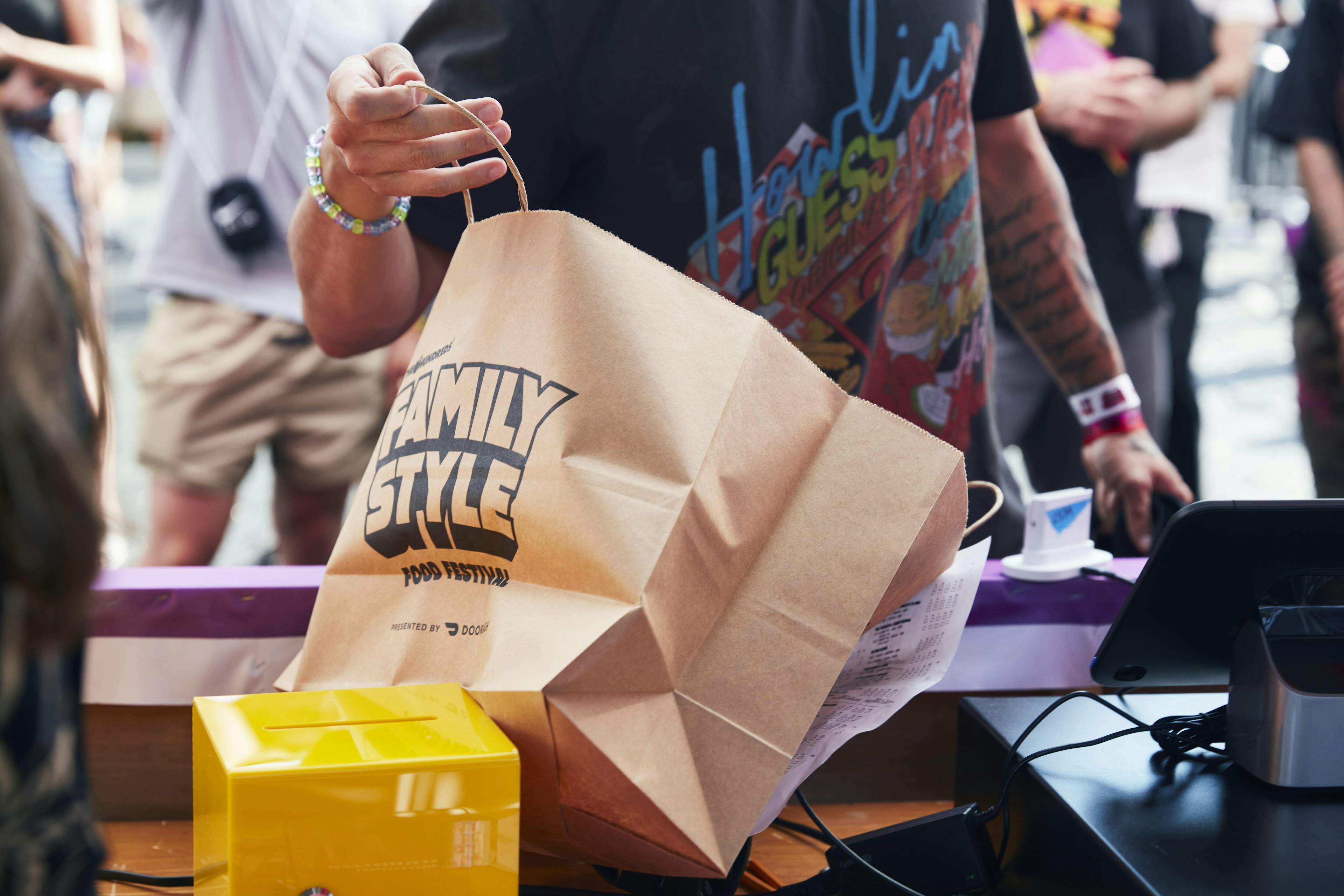 Restaurant employee packing an order into a branded delivery bag