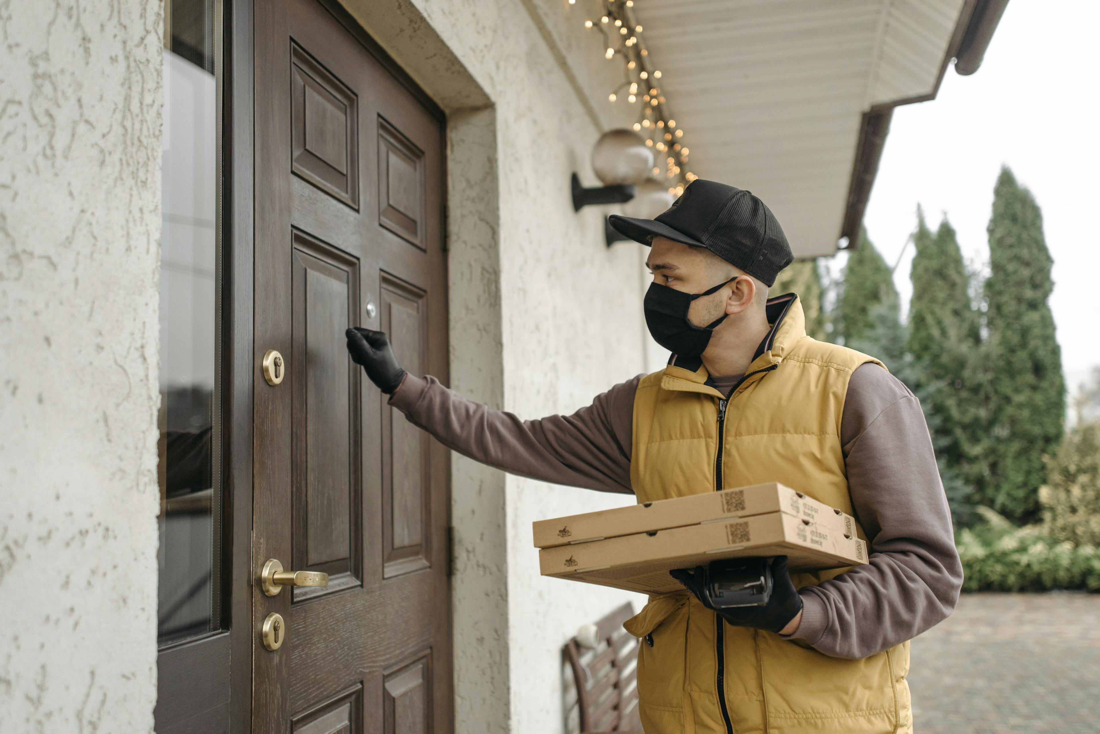 Image of a food delivery courier dropping off an order to a customer's front door