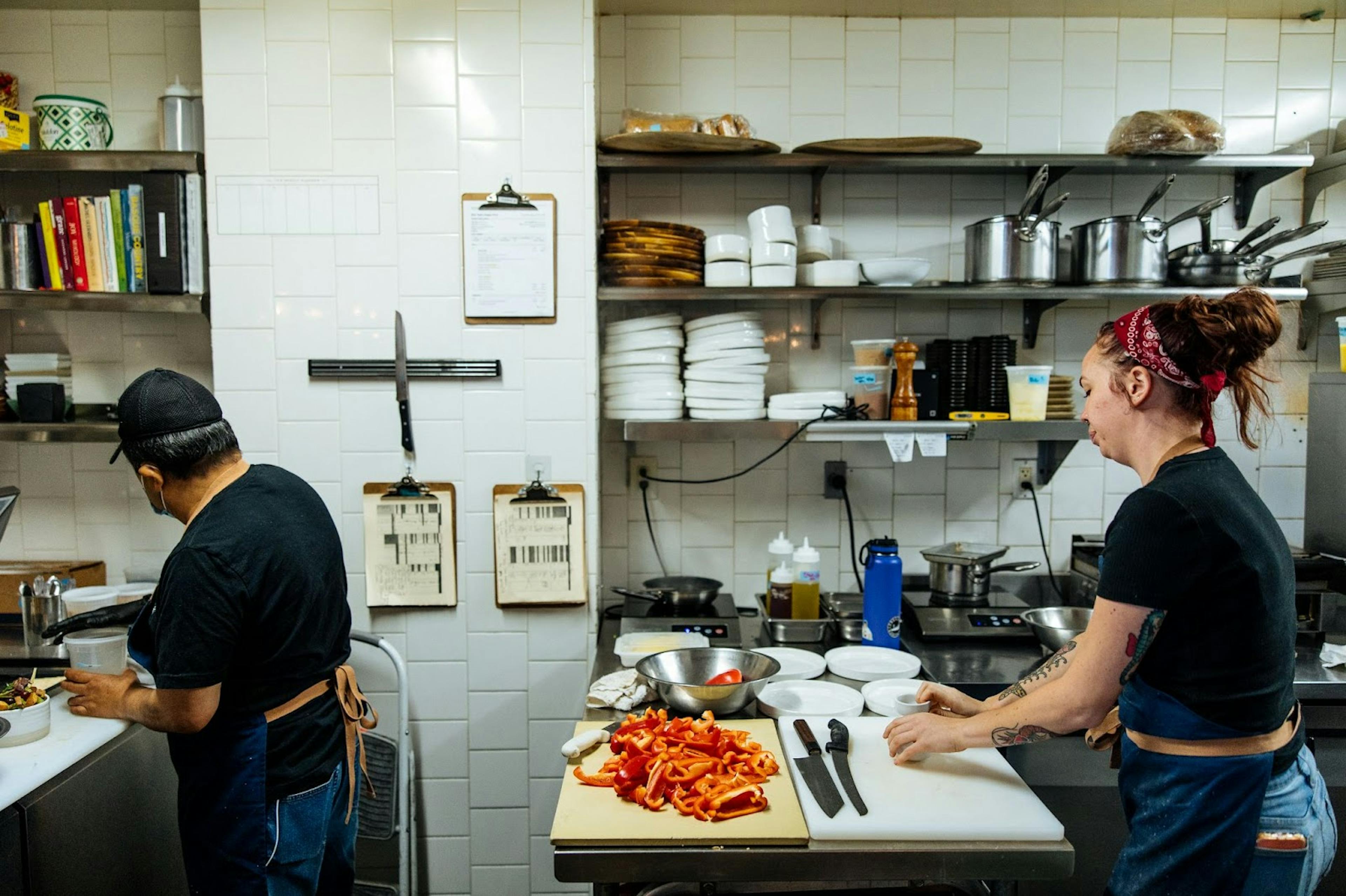 Image of two restaurant employees working in the back-of-house