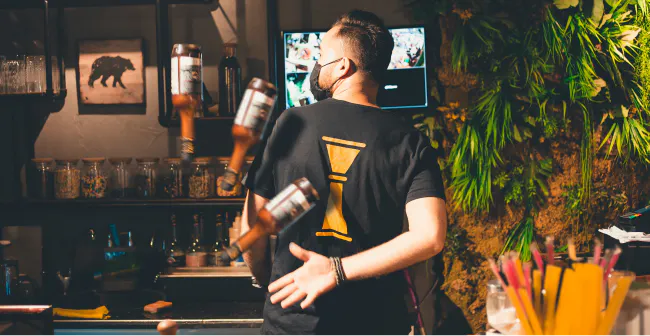 Image of a bartender making a drink in a restaurant