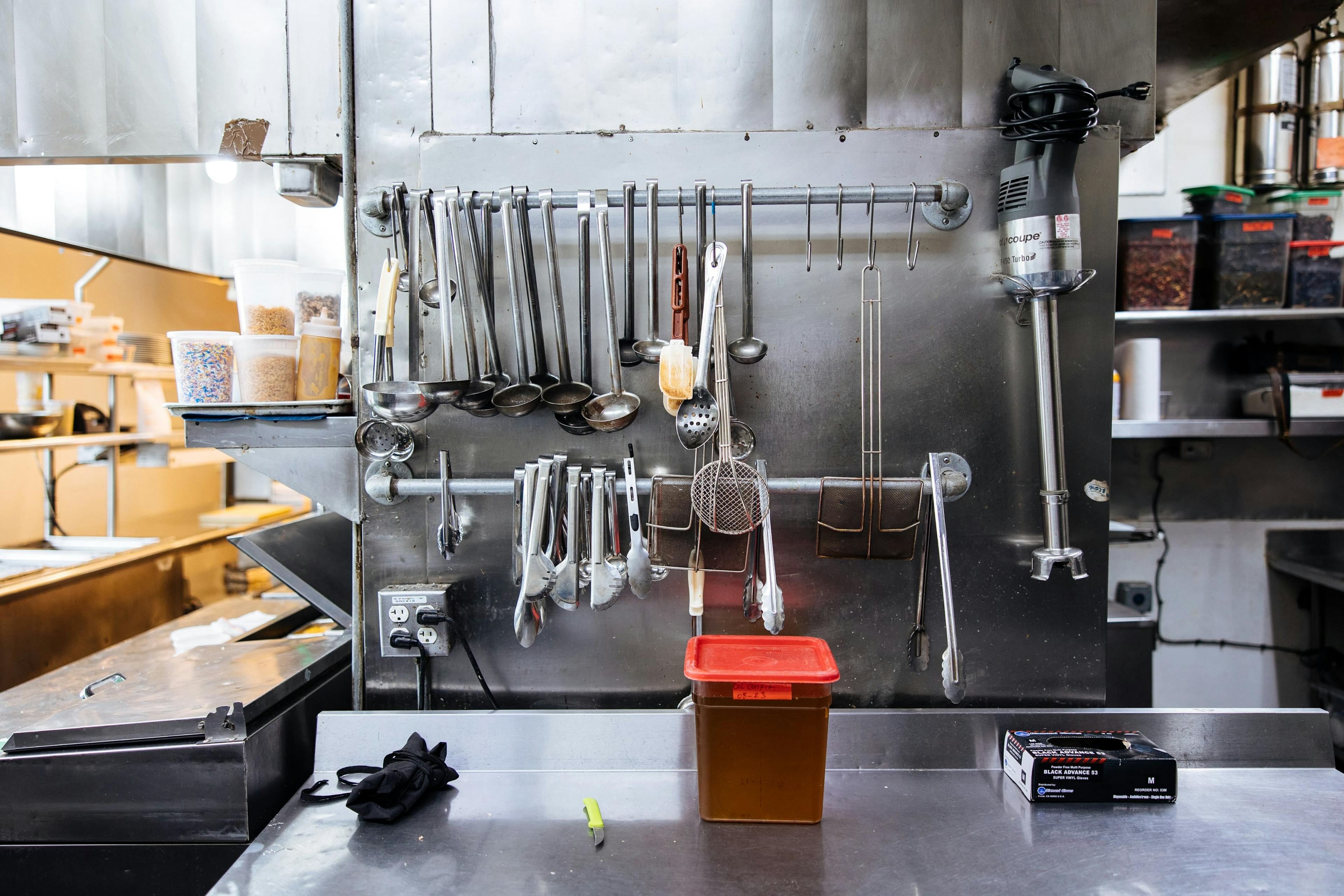 Image of restaurant tools hanging in the kitchen