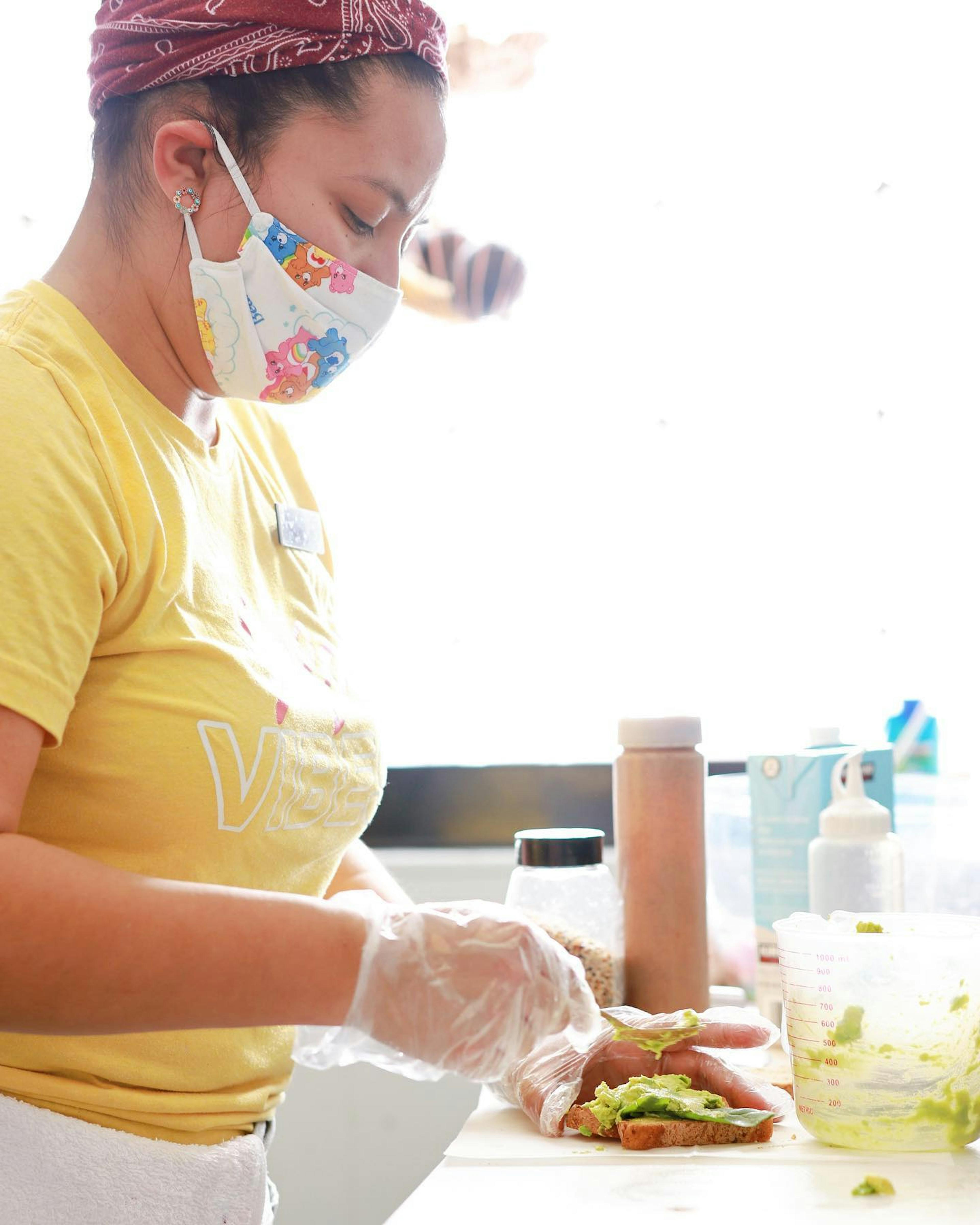 Image of a Juice Vibe Bar employee making avocado toast