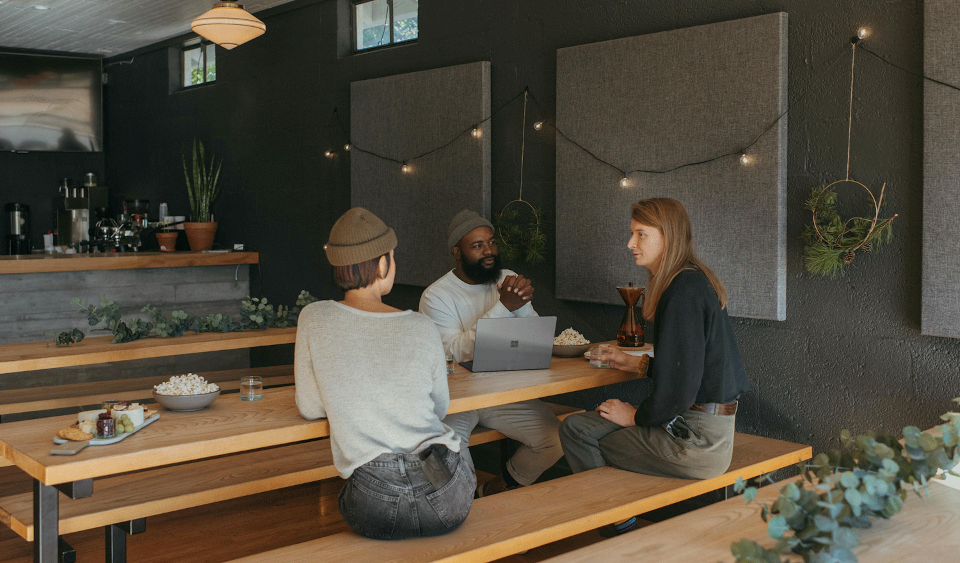 Image of three restaurant employees discussing performance 