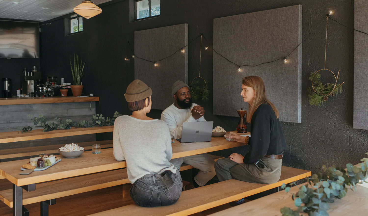 Image of three restaurant employees discussing performance