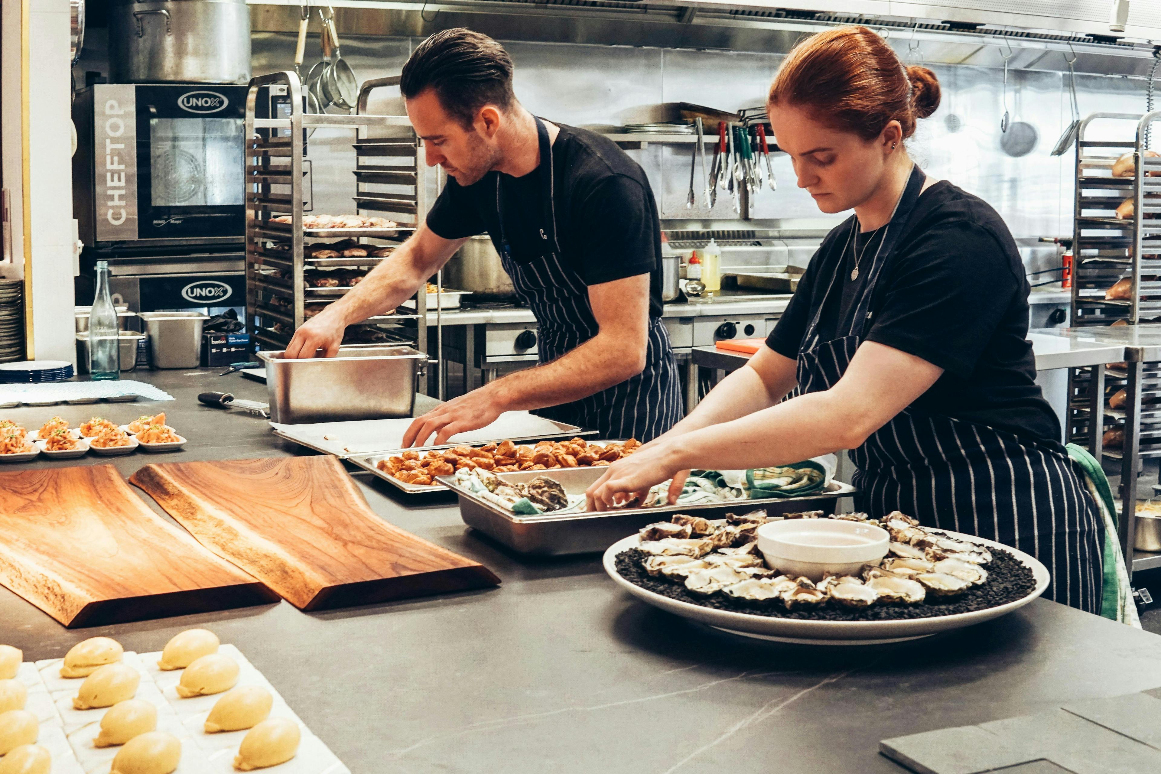 Some restaurant staff making food. 