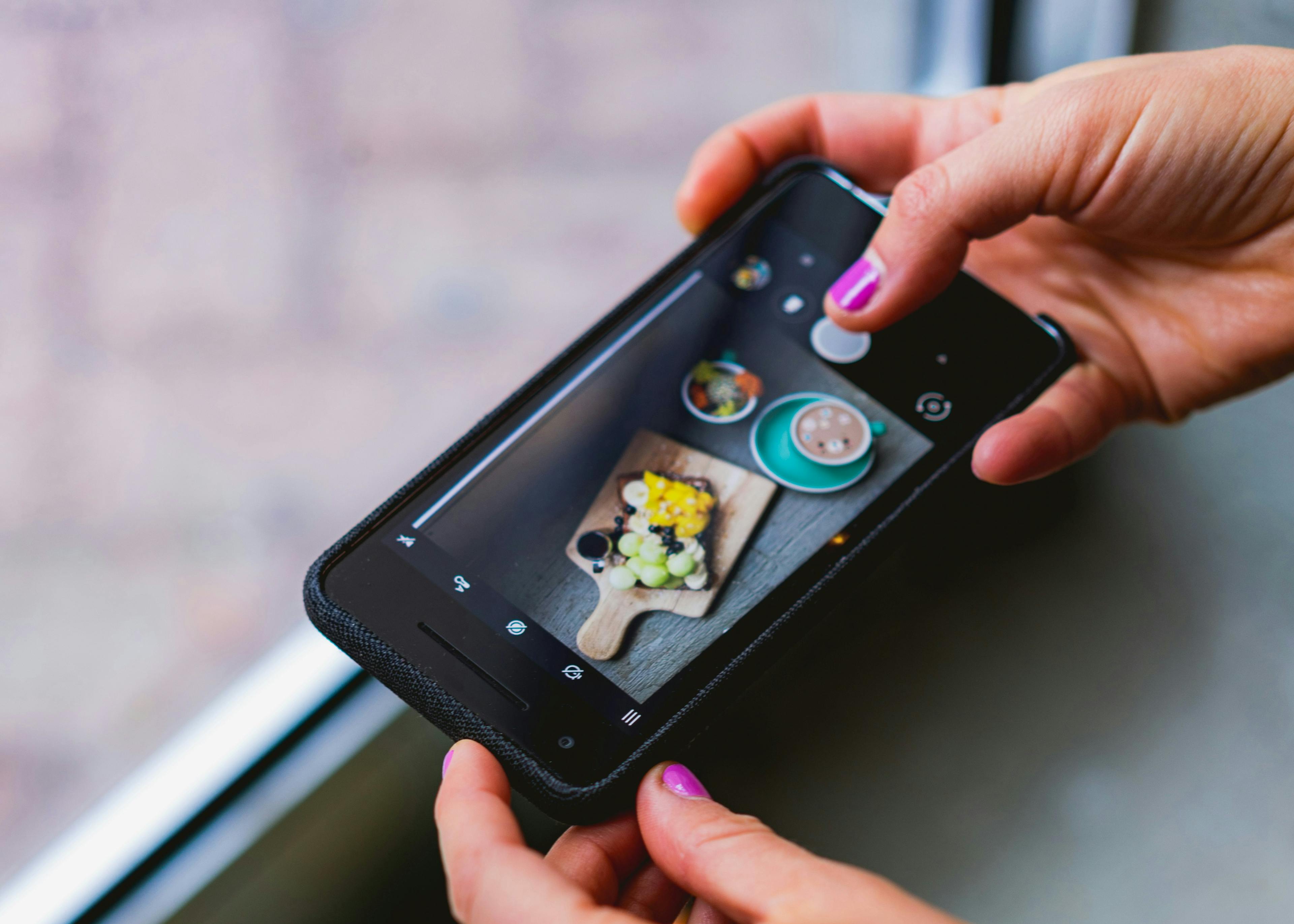 A video being taken at a restaurant for Instagram Reels. 