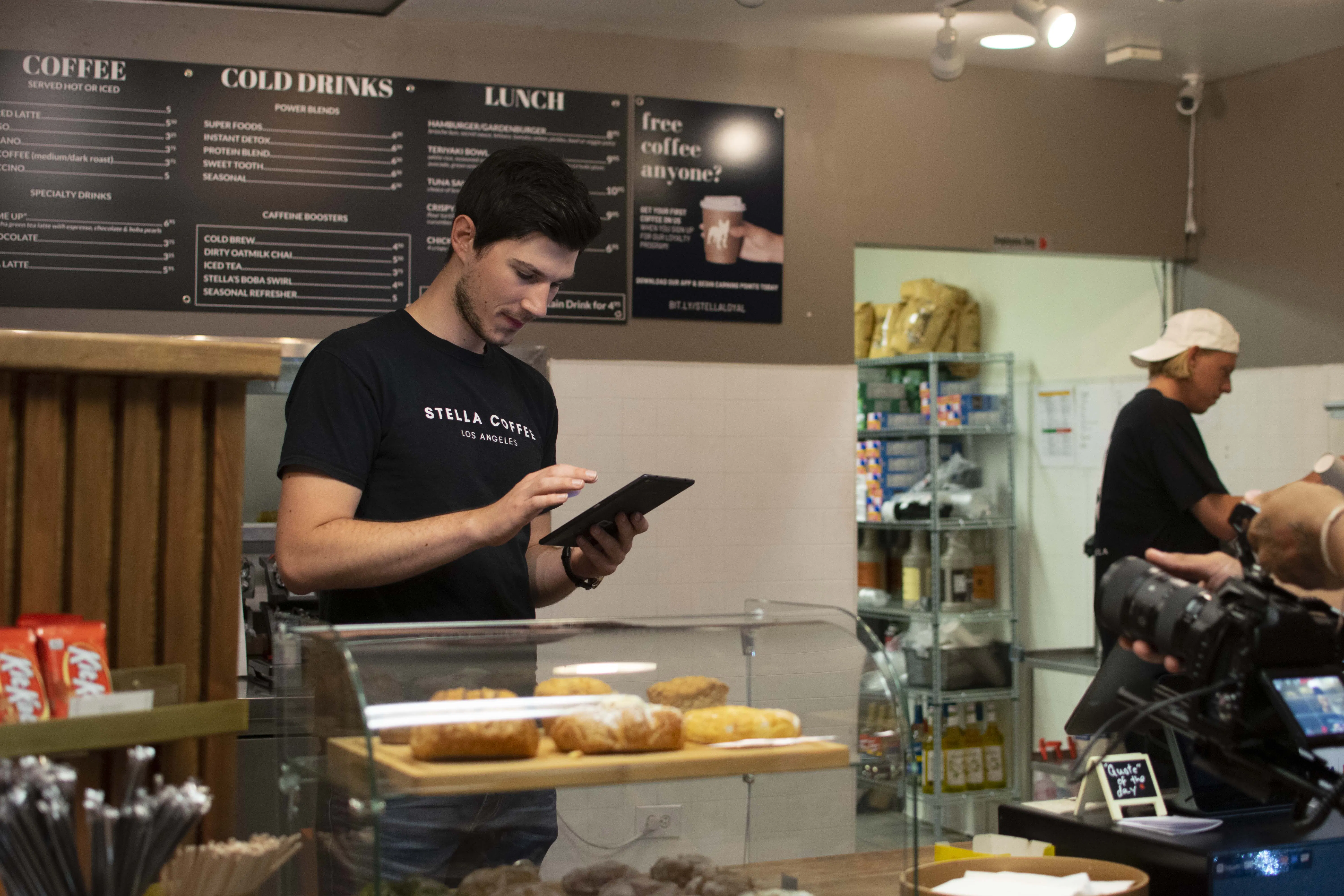 Stella Coffee employee using Otter tablet at cafe.