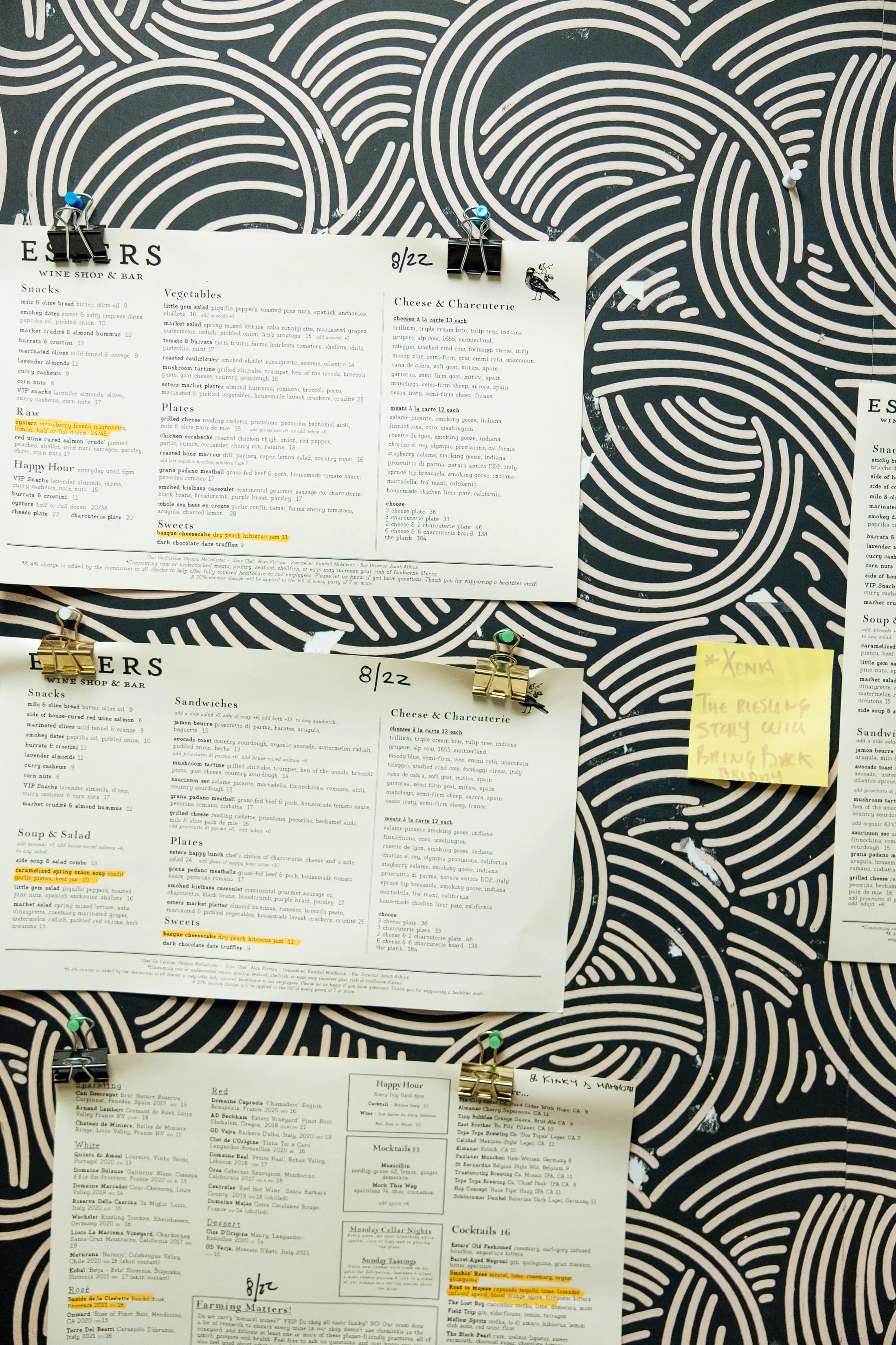 Restaurant menus hanging up on a wall.