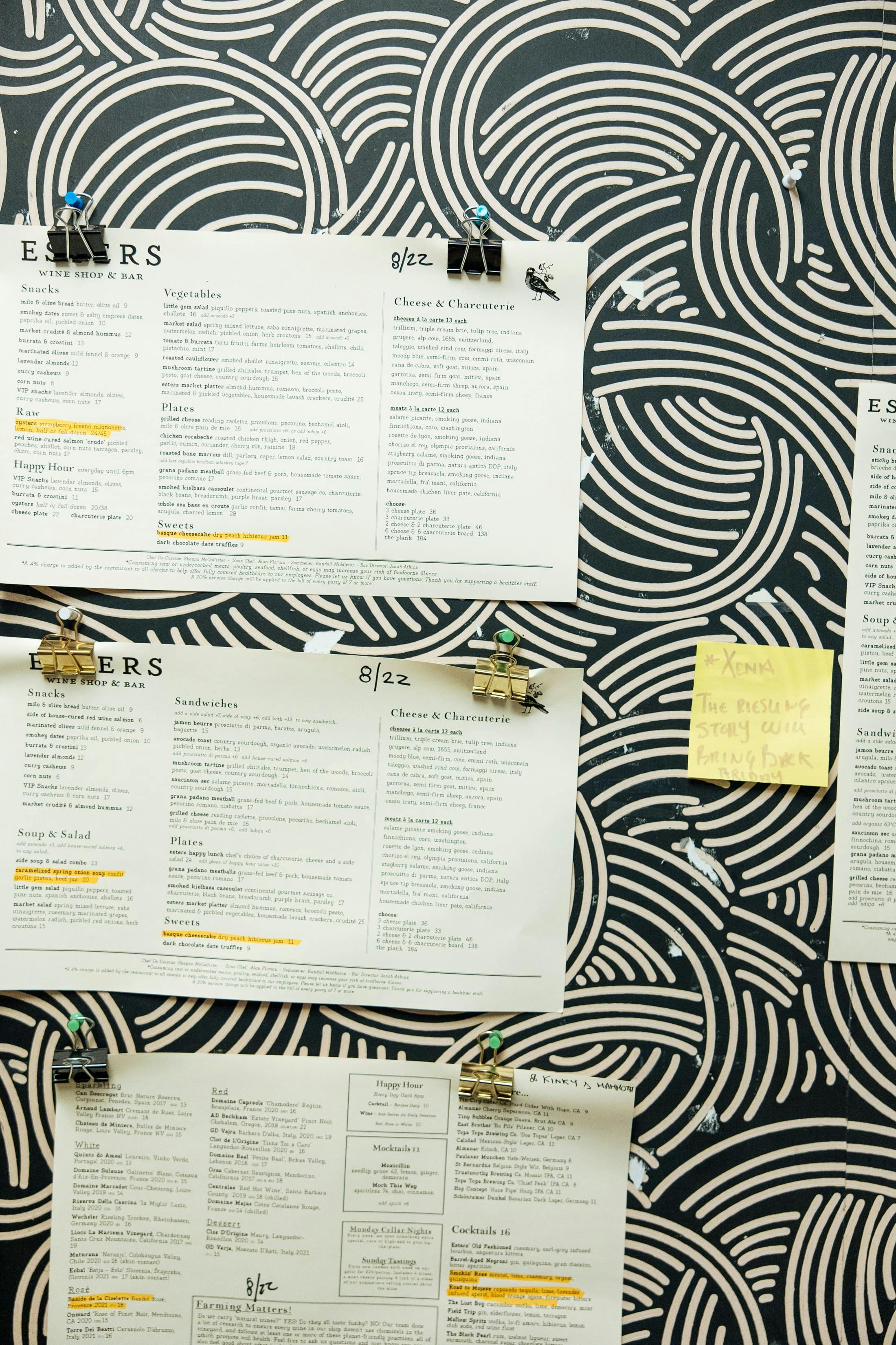 Restaurant menus hanging up on a wall.