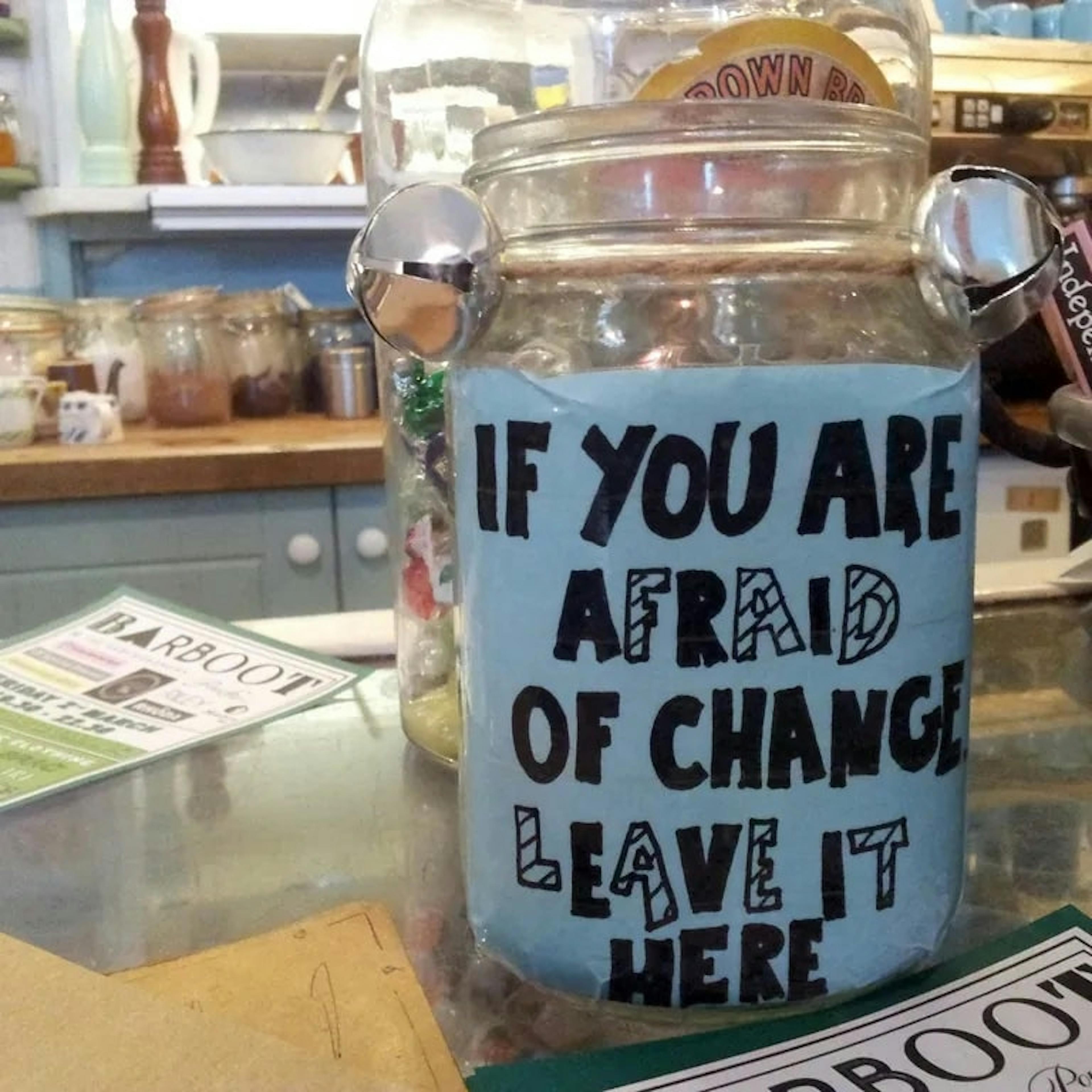 Image of a clever tip jar that says "If you are afraid of change leave it here!"