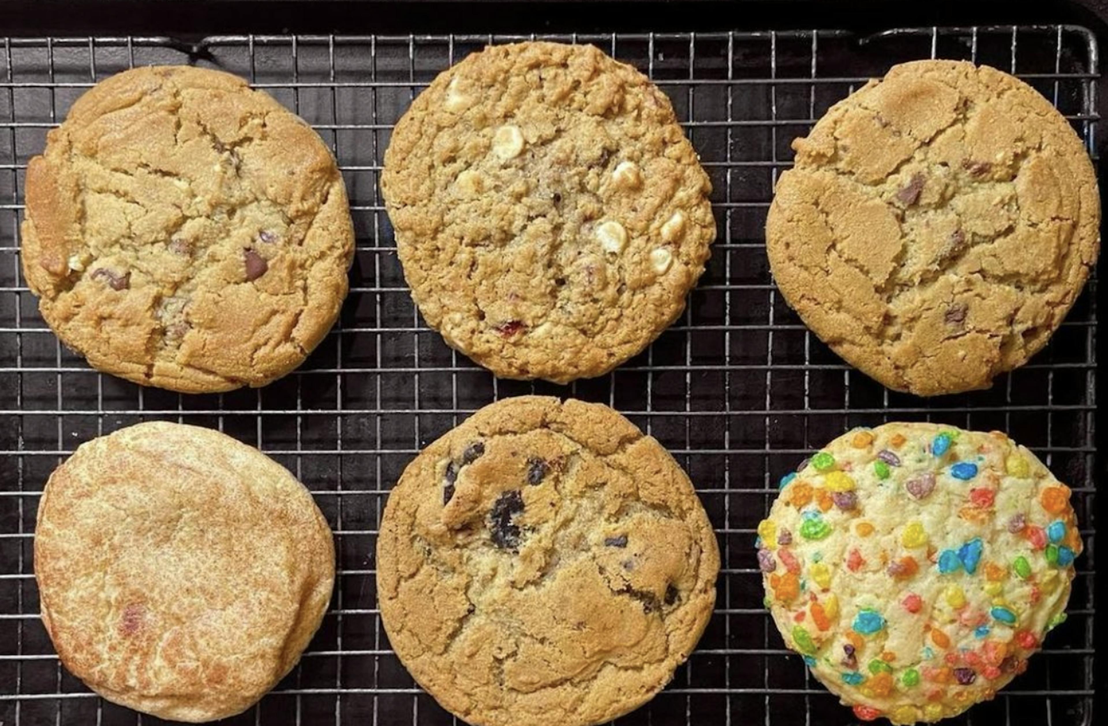 Image of six Midnight Cookie Co cookies on a baking sheet