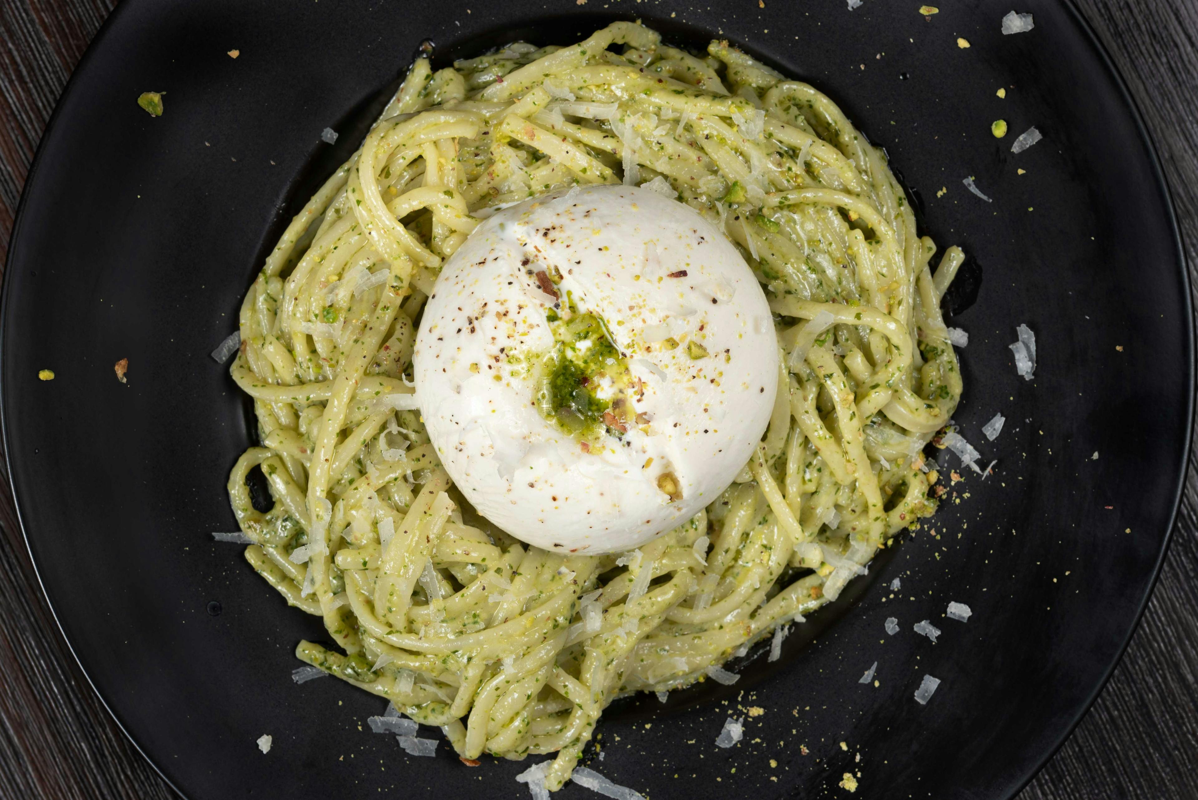 Image of pesto pasta with burrata on top from Casina Montreal