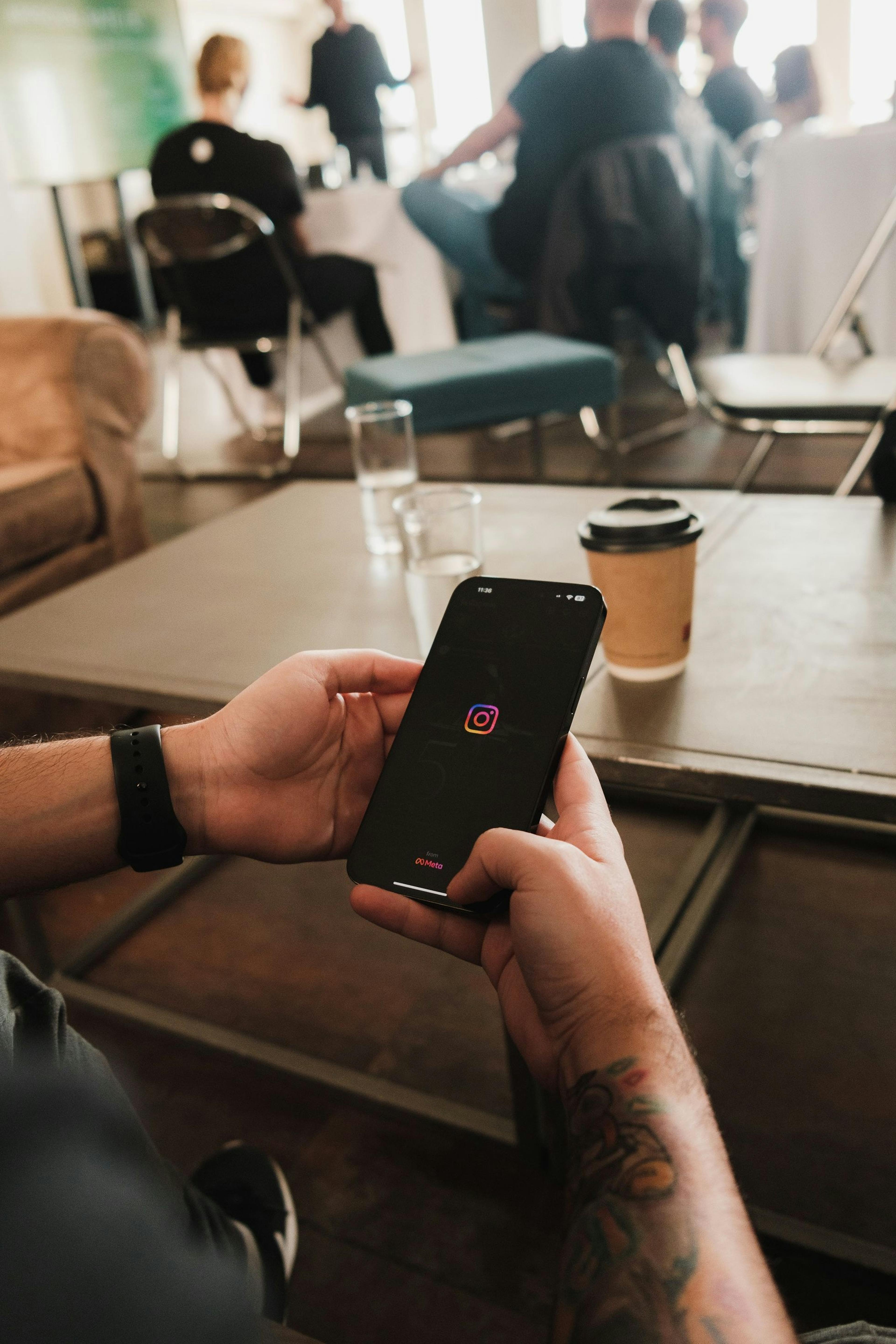 Image of restaurant worker scrolling on iPhone behind the counter