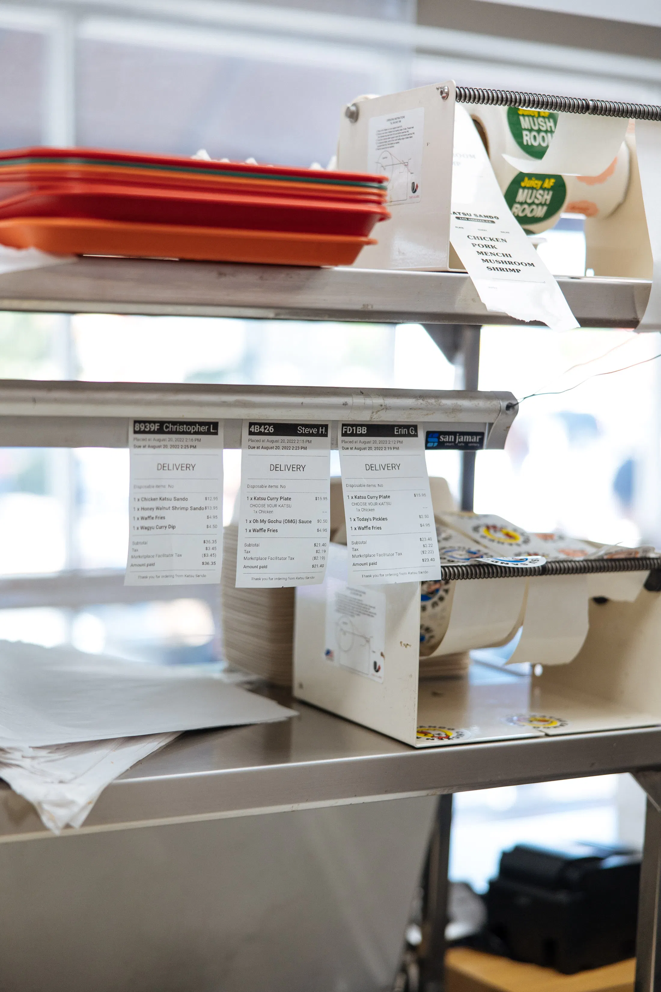 Image of restaurant order tickets hanging that were printed from the POS system