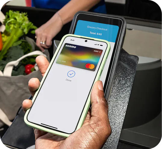 A payment being made with a mobile phone via tap.