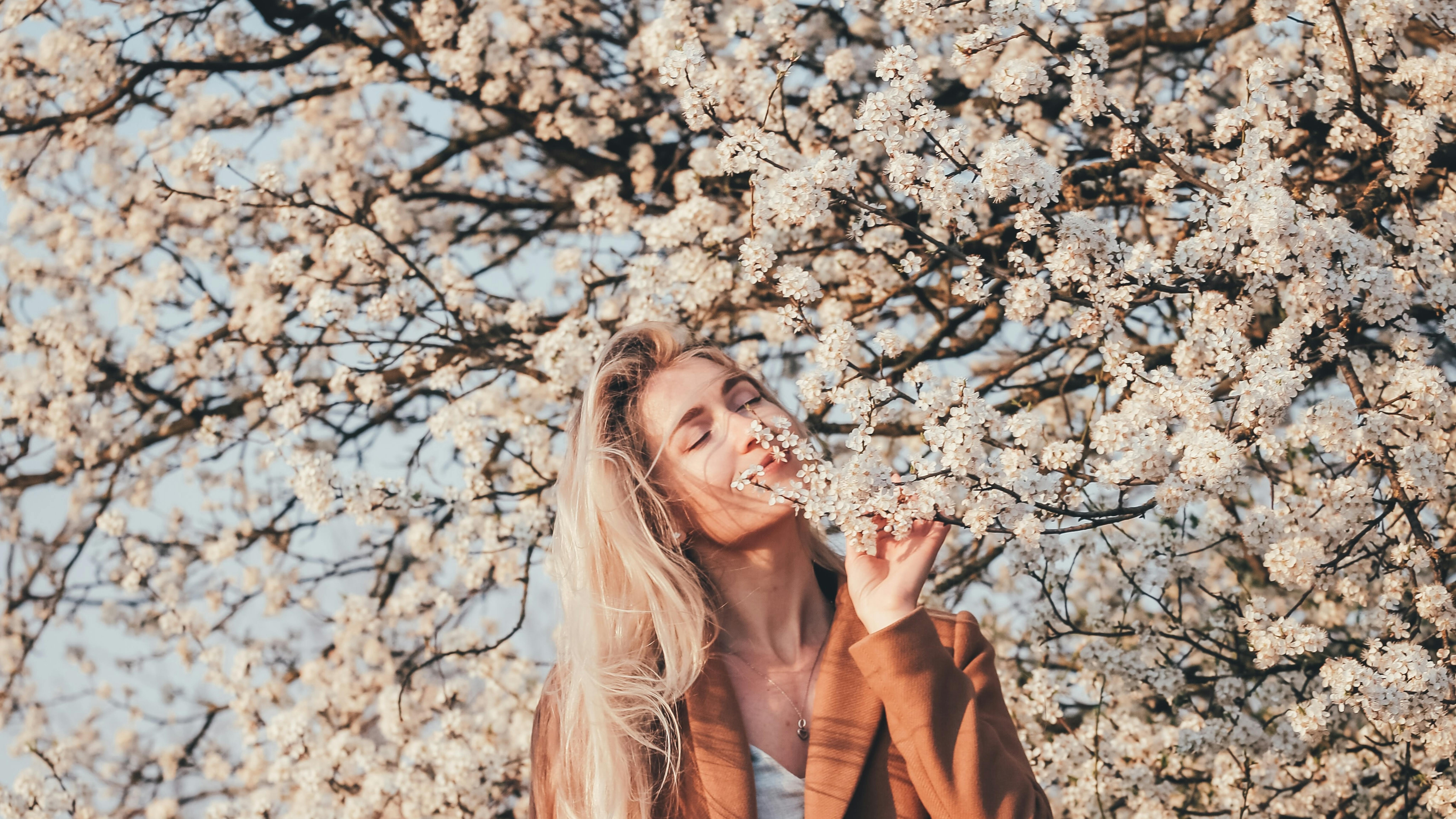 A women surrounded by cherry blossoms.