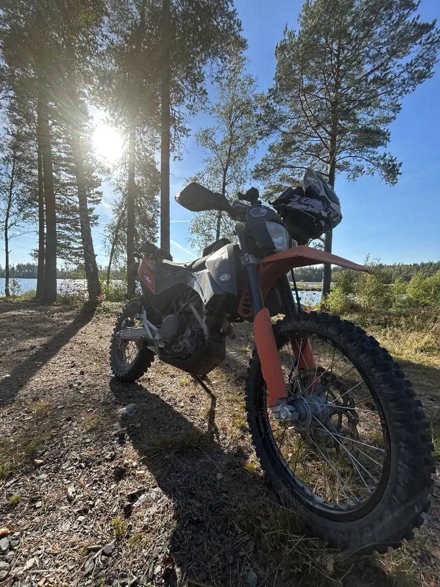 my bike parked in the sunshine, by a lake