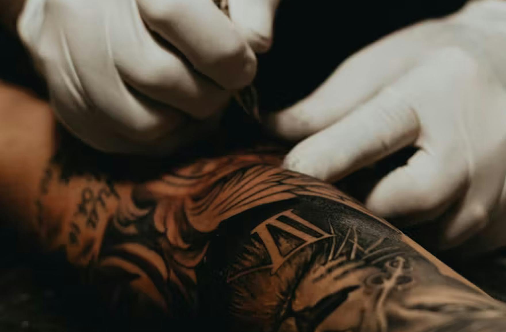 arm being tattooed