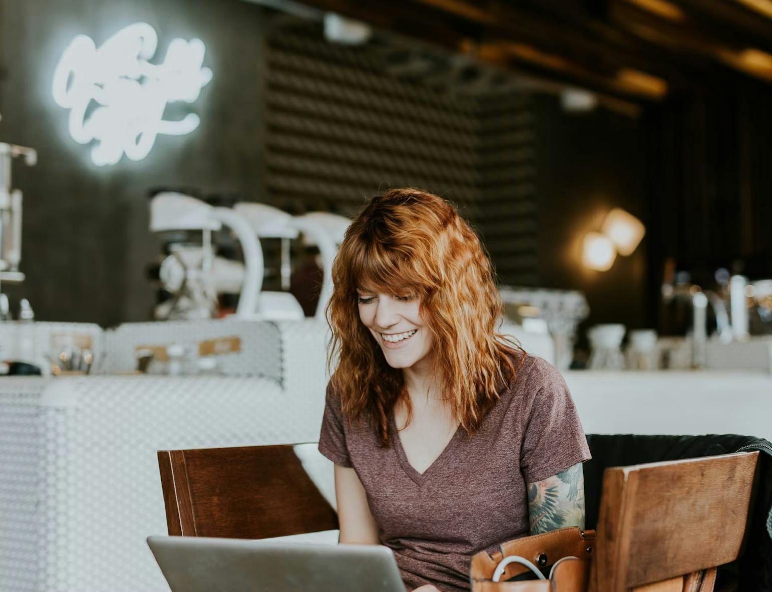 tattoed woman working at a casual workspace
