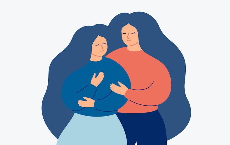 Kobieta pociesza inną kobietę.