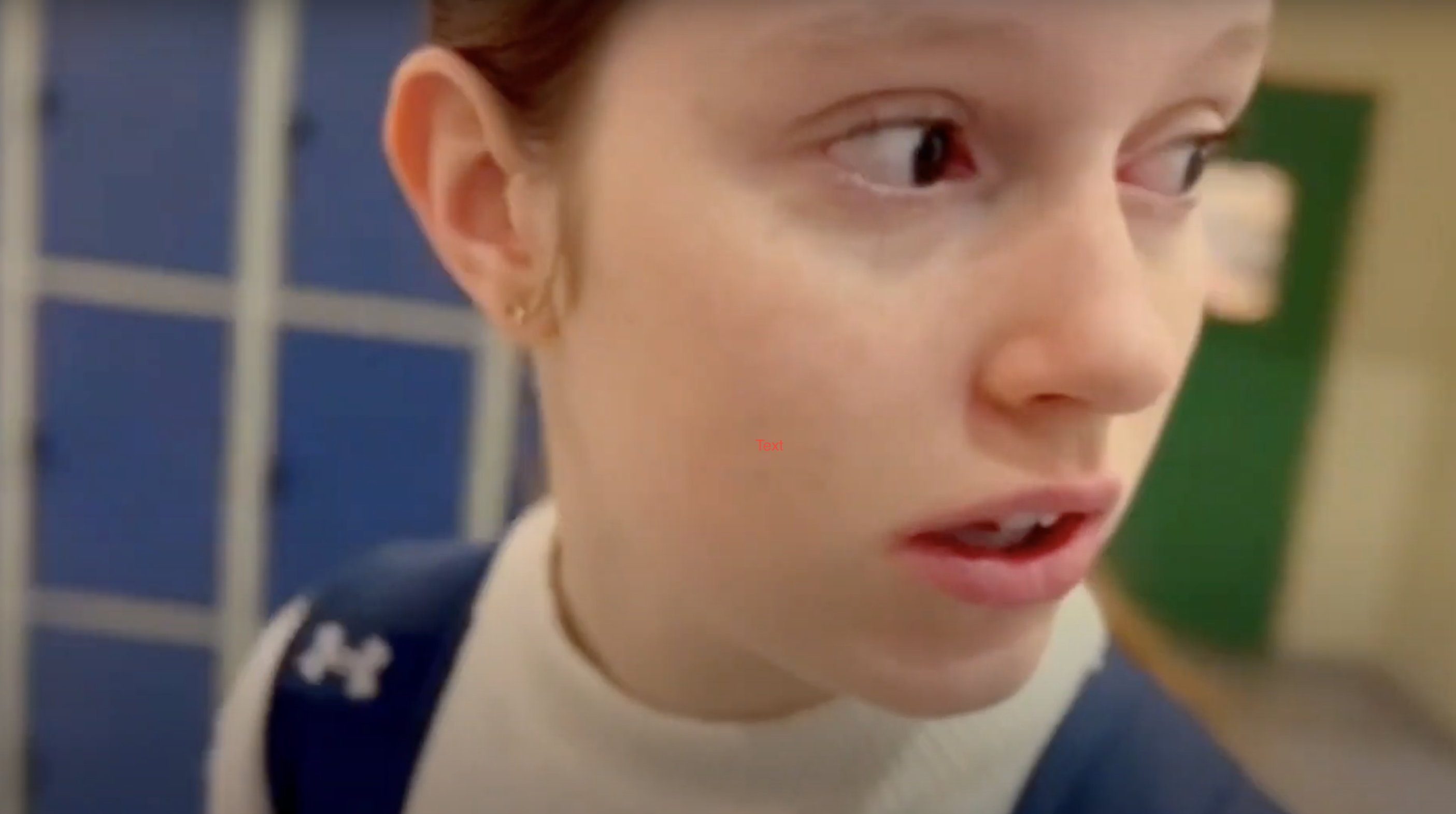 Ung stúlka með bláa skólatösku á bakinu horfir aftur fyrir sig og virðist skelkuð.