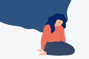 A person sits on their knees with a sad face.