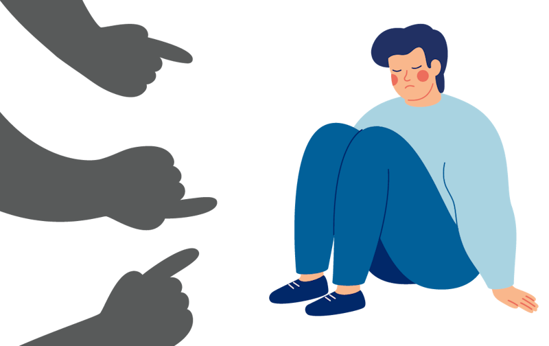 A sad child sits alone while several fingers point at them.