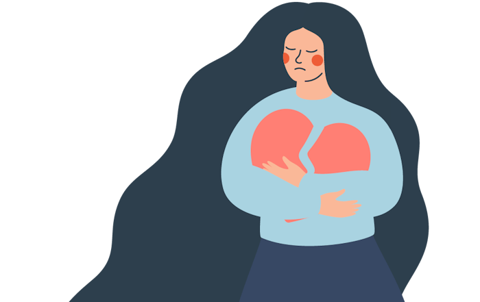A woman holds a broken heart.