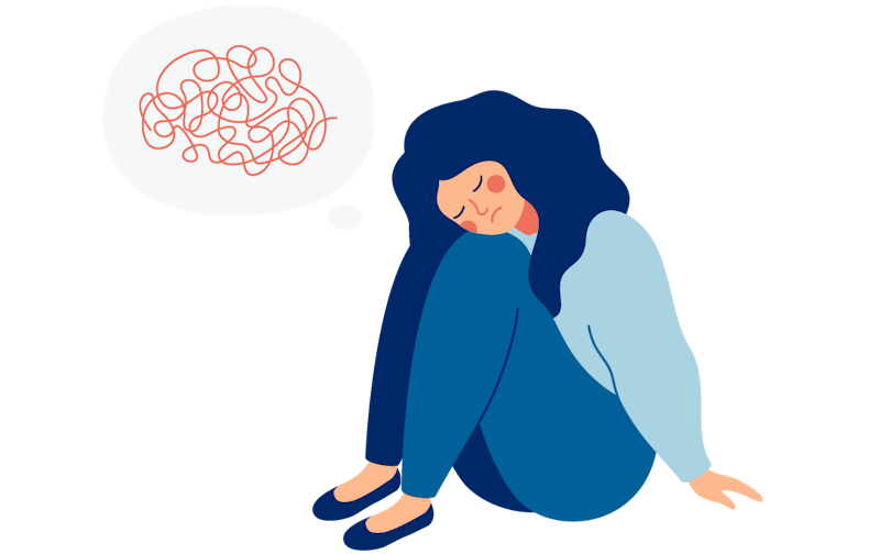 A woman sits on the floor. Her mind is in distress.