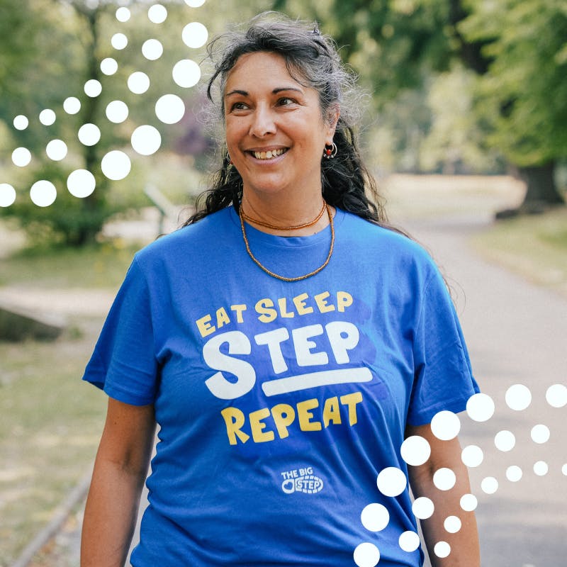  woman walking in Big Step t-shirt, smiling