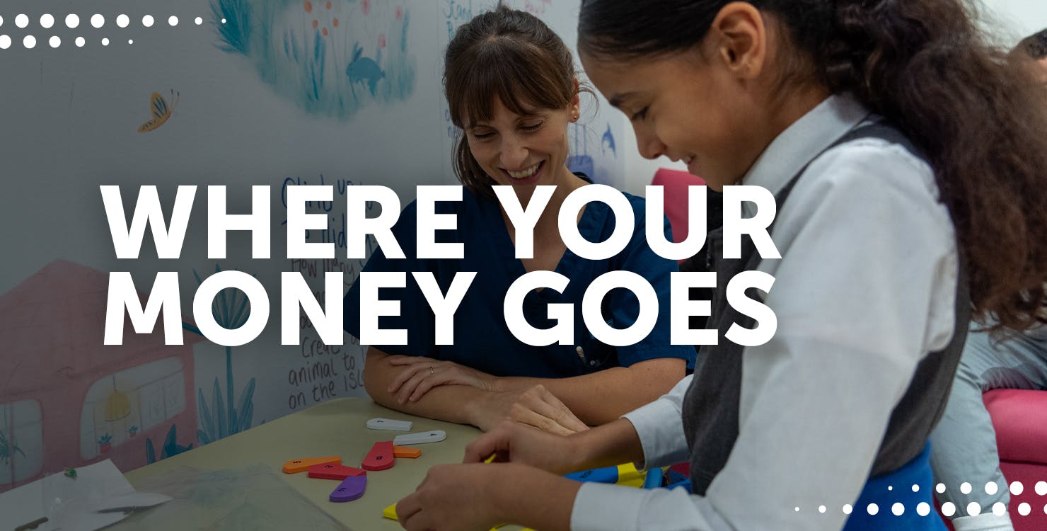 Nurse smiling, with young girl patient, also smiling