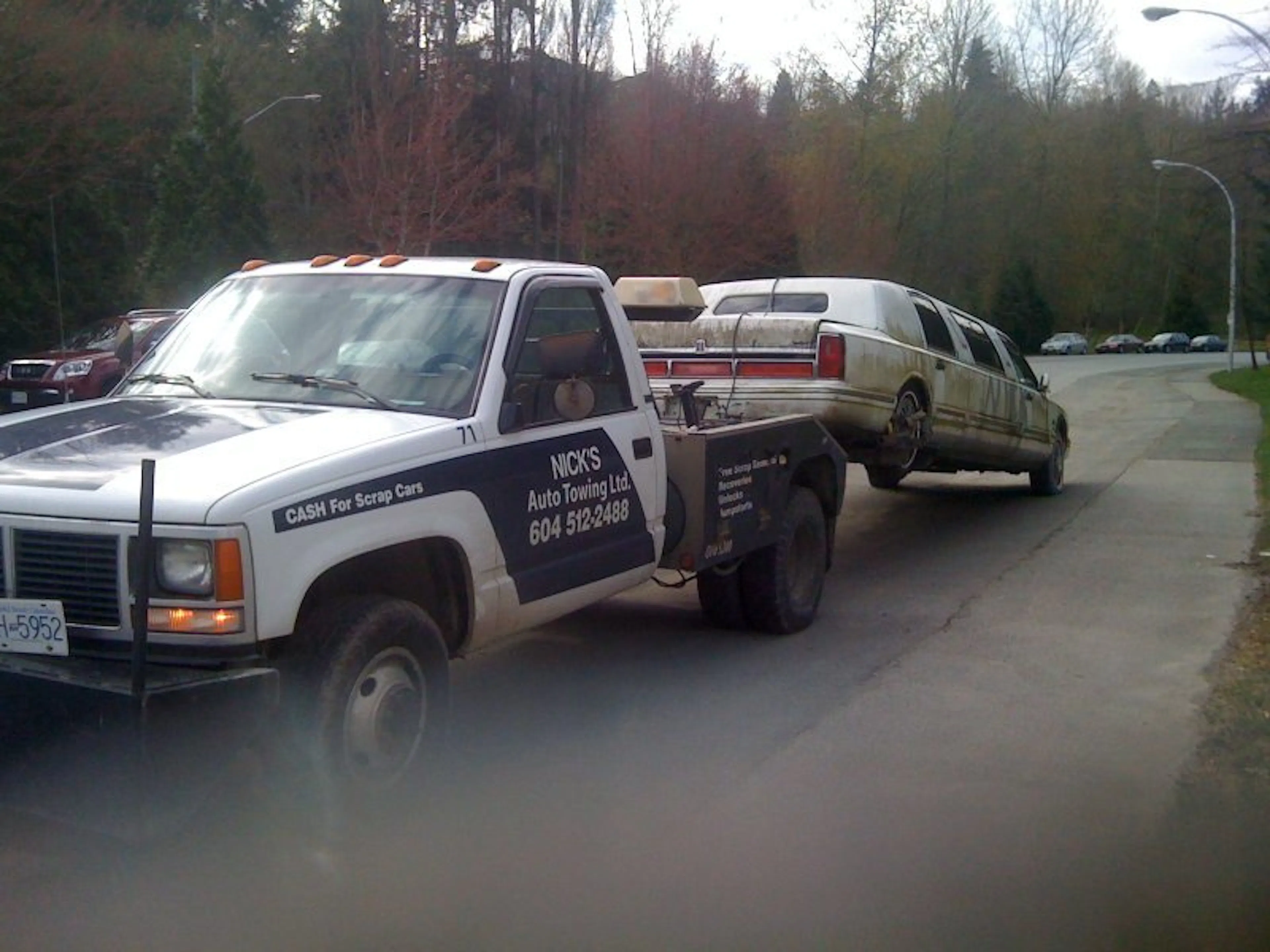 Nick's Auto Towing picking up a white limousine