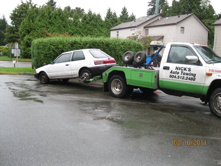 Nick's Auto Towing is picking up a white hatchback in Vancouver.