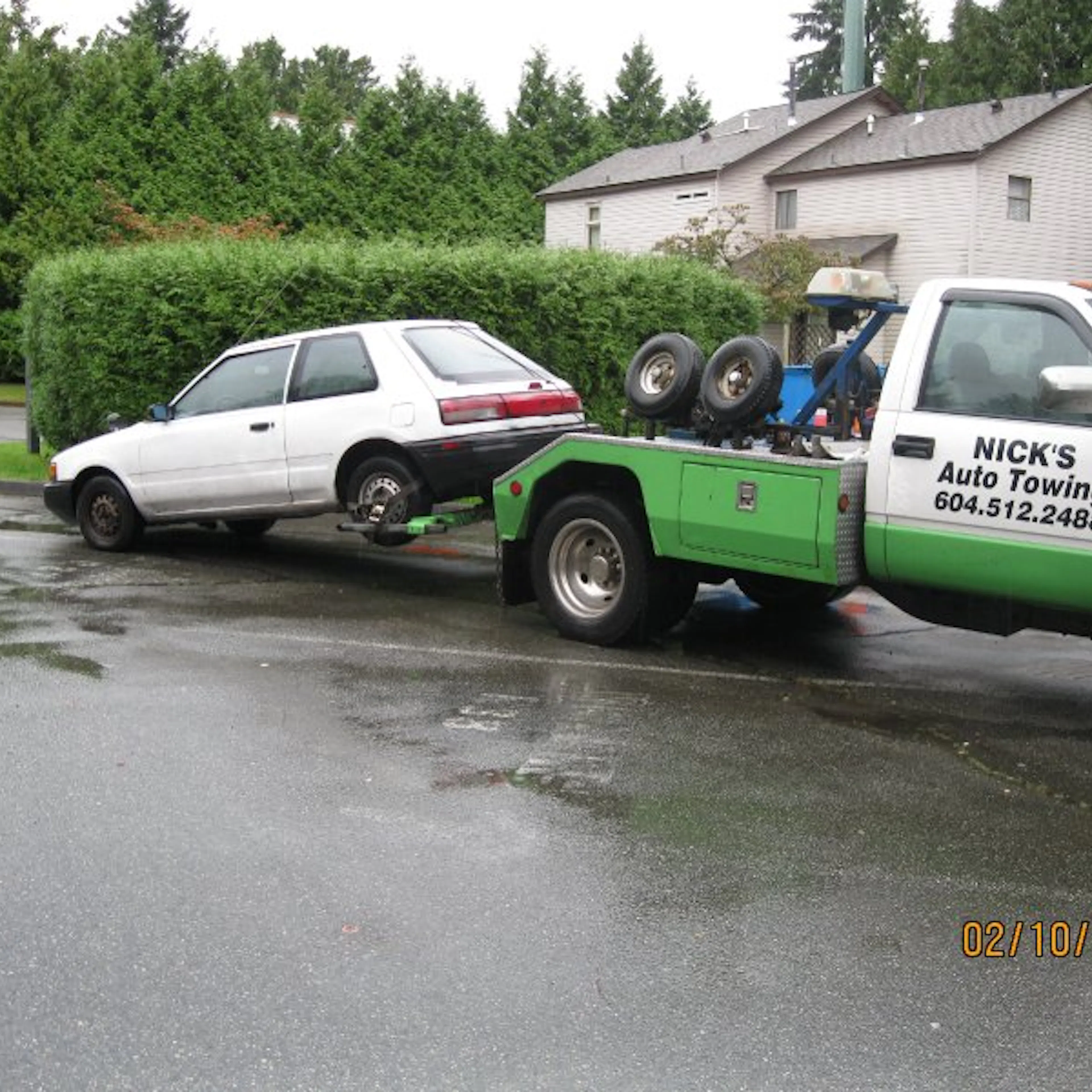Nick's Auto Towing is picking up a white hatchback in Vancouver.