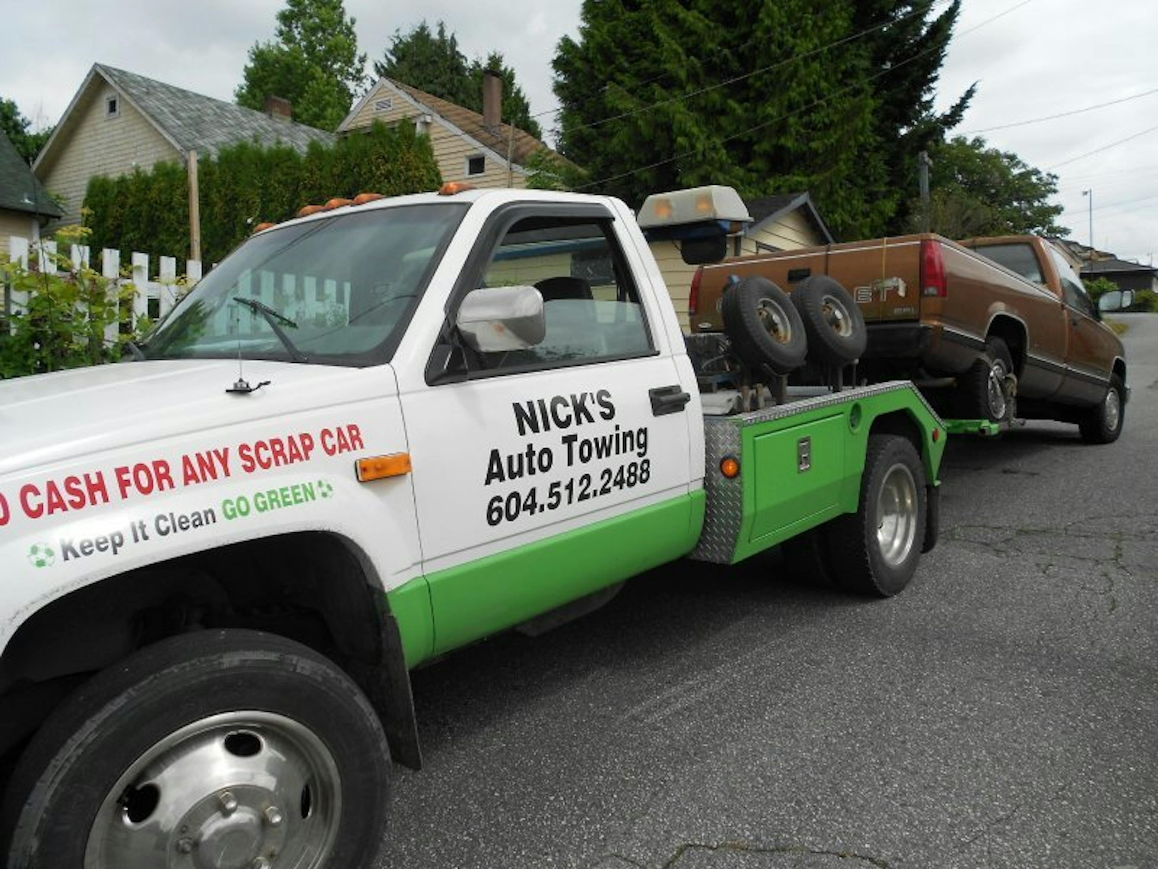 Nick's Auto Towing picking up a Chevy truck.