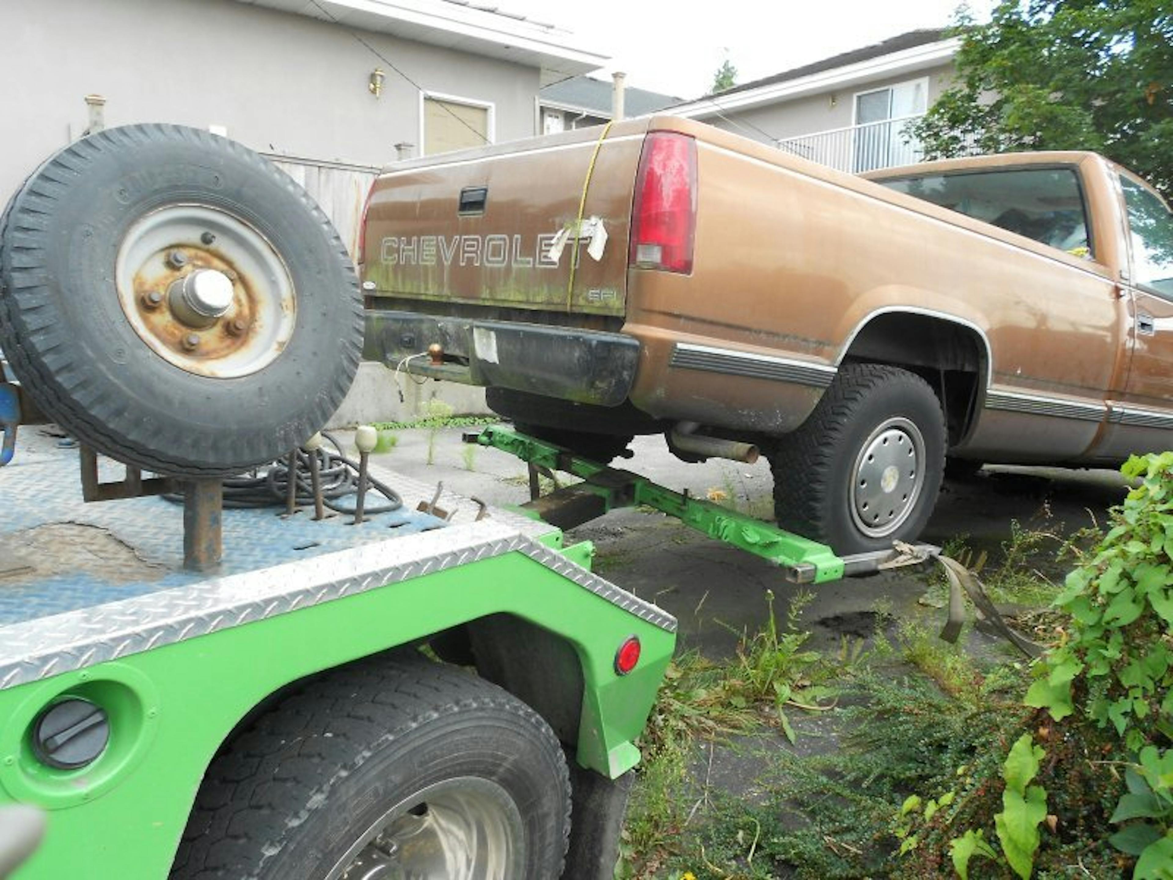 Nick's Auto Towing picking up a Chevy truck.
